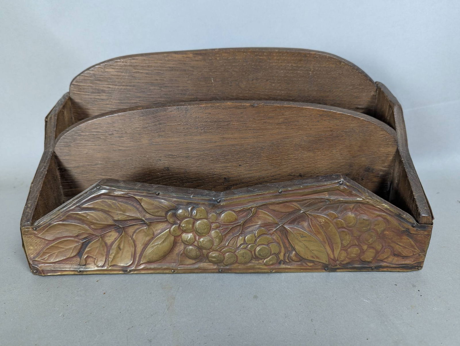 Art Nouveau Desk Organizer with Floral Relief Design: Wooden desk organizer featuring Art Nouveau design elements with floral and fruit motifs. The front and side panels are adorned with a relief design in warm tones, showcasing leaves and berries. The o