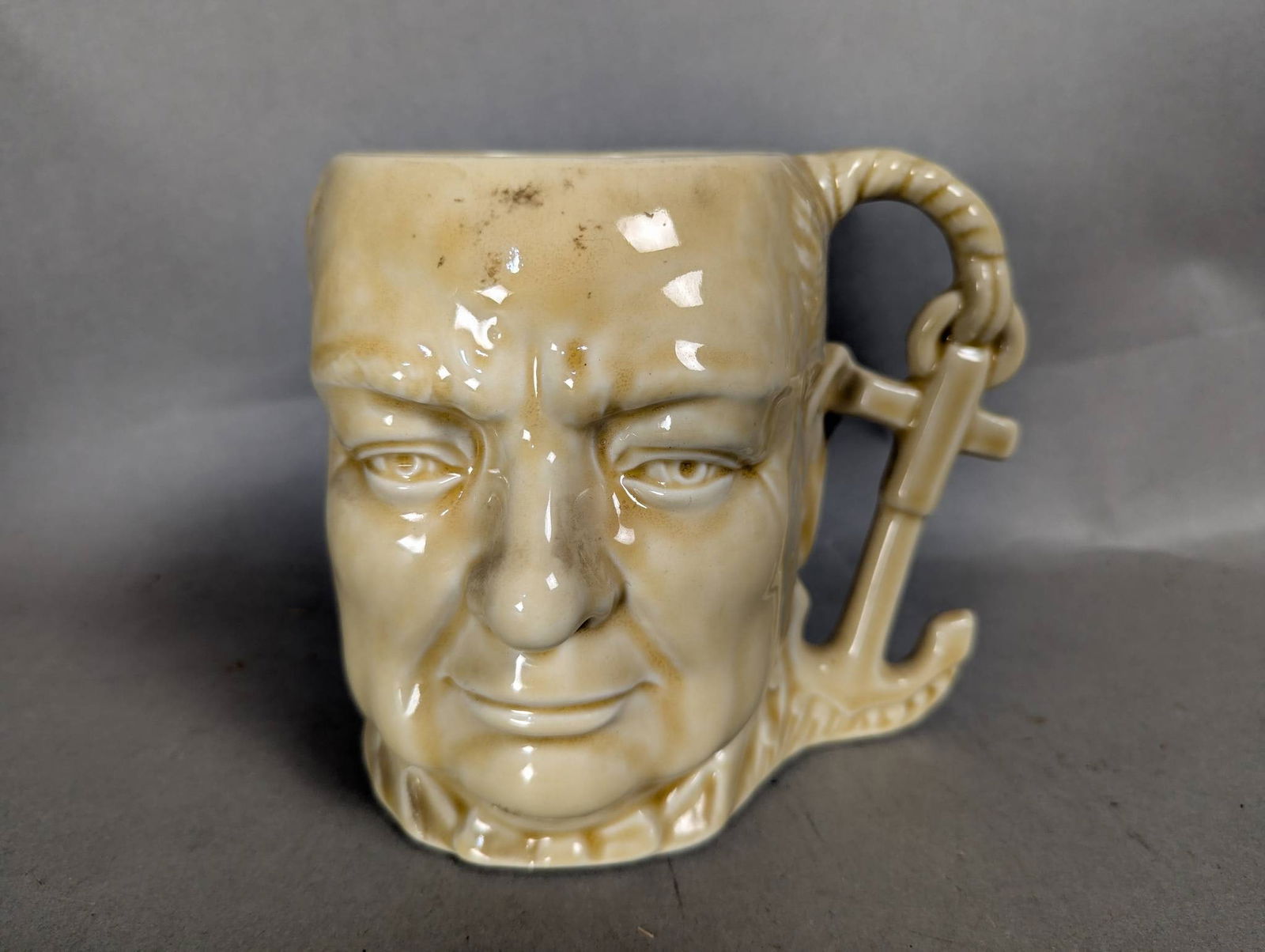 Shorter and Son Large Winston Churchill Character Jug in Dark Beige Taupe: Large Winston Churchill character jug crafted by Shorter and Son in a dark beige or taupe color. The jug features intricate molded detailing of Winston Churchill's likeness, along with an anchor-shape