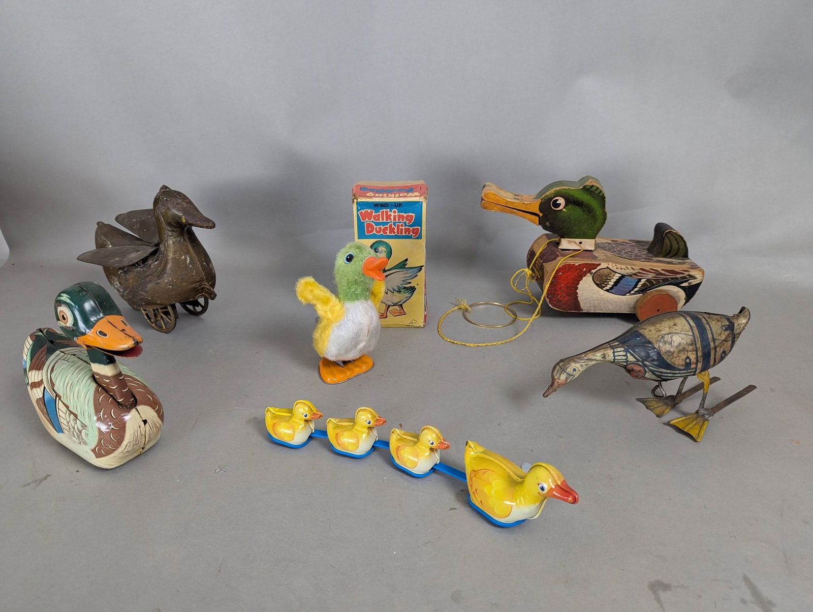 Vintage Duck and Goose Assorted Toys with Pulltoy Wind-up etc: Vintage duck and goose-themed toys, including a pulltoy with dimensions 8 high, 11 wide, and 6 deep. The collection features various items such as a wind-up walking duckling with its original packagin