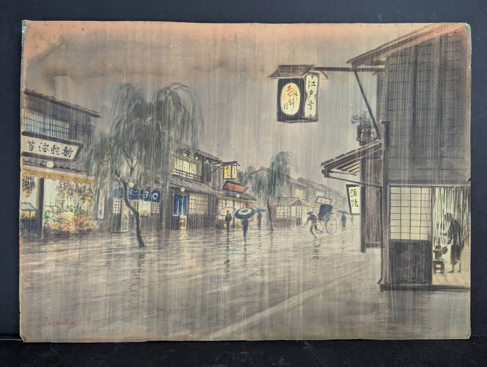 Japanese Watercolor Painting by Eizo Kato Depicting Street Scene: Japanese watercolor painting by artist Eizo Kato measuring 26 1/2 inches high by 19 inches wide. The artwork shows a rainy street scene with pedestrians carrying umbrellas, a rickshaw, and illuminated