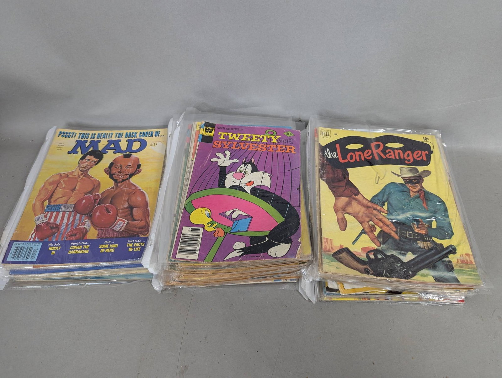 51 Vintage Comic Books and Mad Magazines: 51 vintage comic books and Mad magazines featuring a variety of classic characters and titles. This collection includes Mad magazines, Looney Tunes titles like Tweety and The Road Runner, Archie comic