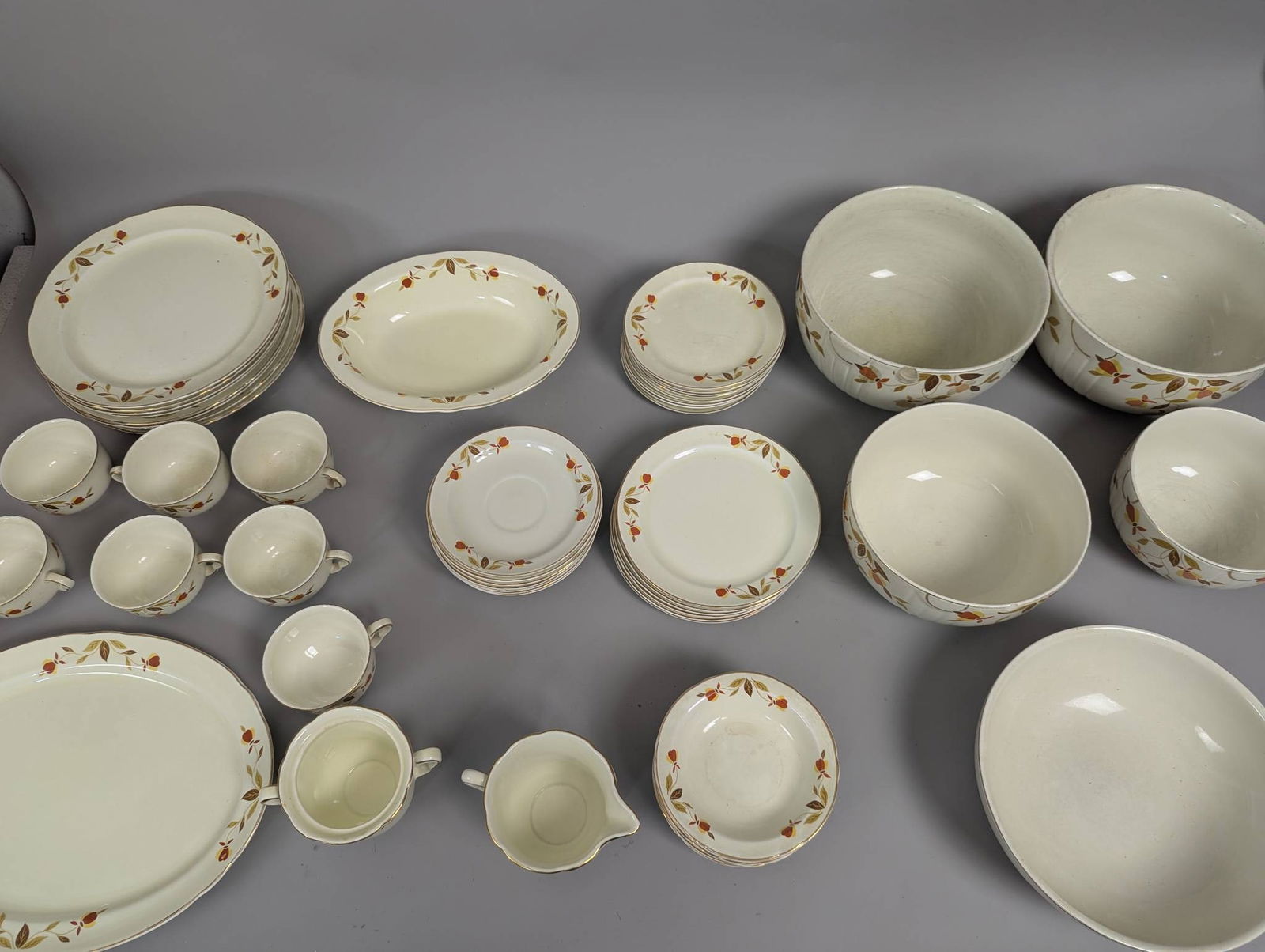 Hall China Autumn Leaf Pattern Dinnerware 55 Pieces: 55 pieces of dinnerware in the popular Autumn Leaf pattern produced by Hall China for the Jewel Tea Company. Originally introduced in 1939 and re-issued in 1978. The largest bowl measures 9 inches in