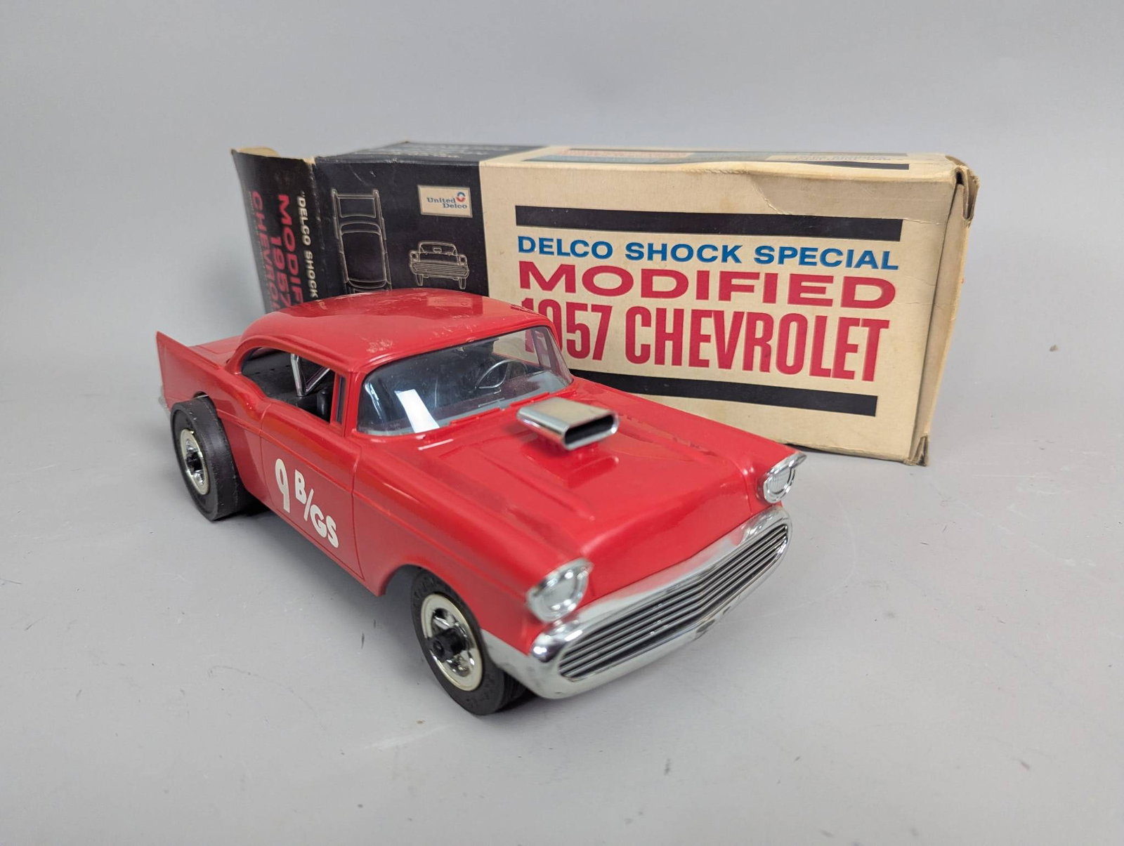 Modified 1957 Chevrolet Delco Shock Special Model Car in Box: Modified 1957 Chevrolet Delco Shock Special model car made by United Motors Service, under General Motors. The model is completely assembled and features a red exterior with decals and chrome trim. Th