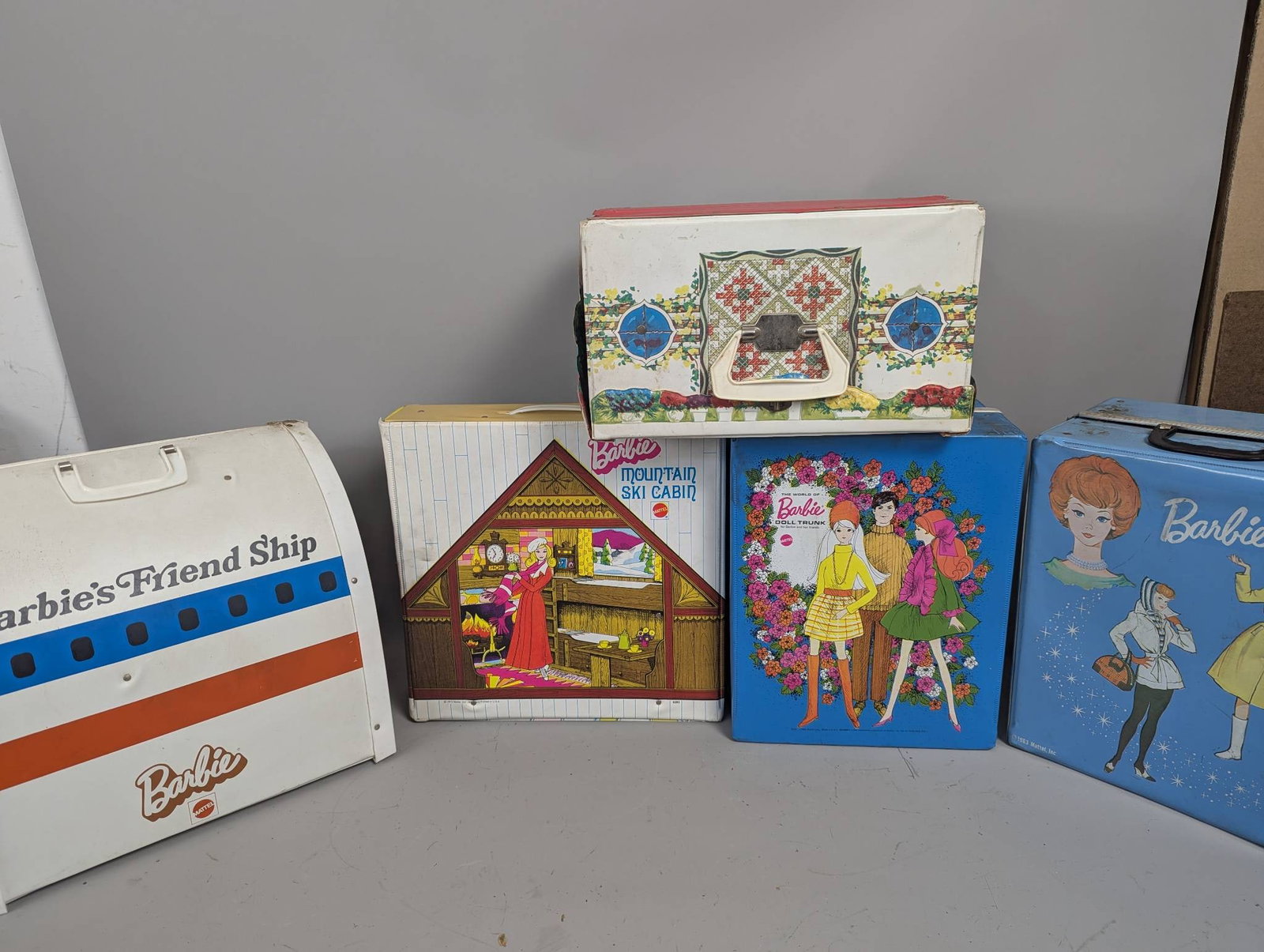 1960s Barbie and Ideal Cases and Playsets Collection: 1960s Barbie and Ideal cases and playsets comprising four Barbie cases and one Ideal playset. Included are the Barbie Friend Ship airplane case measuring 13 high by 13 wide by 14 deep, the Barbie Moun