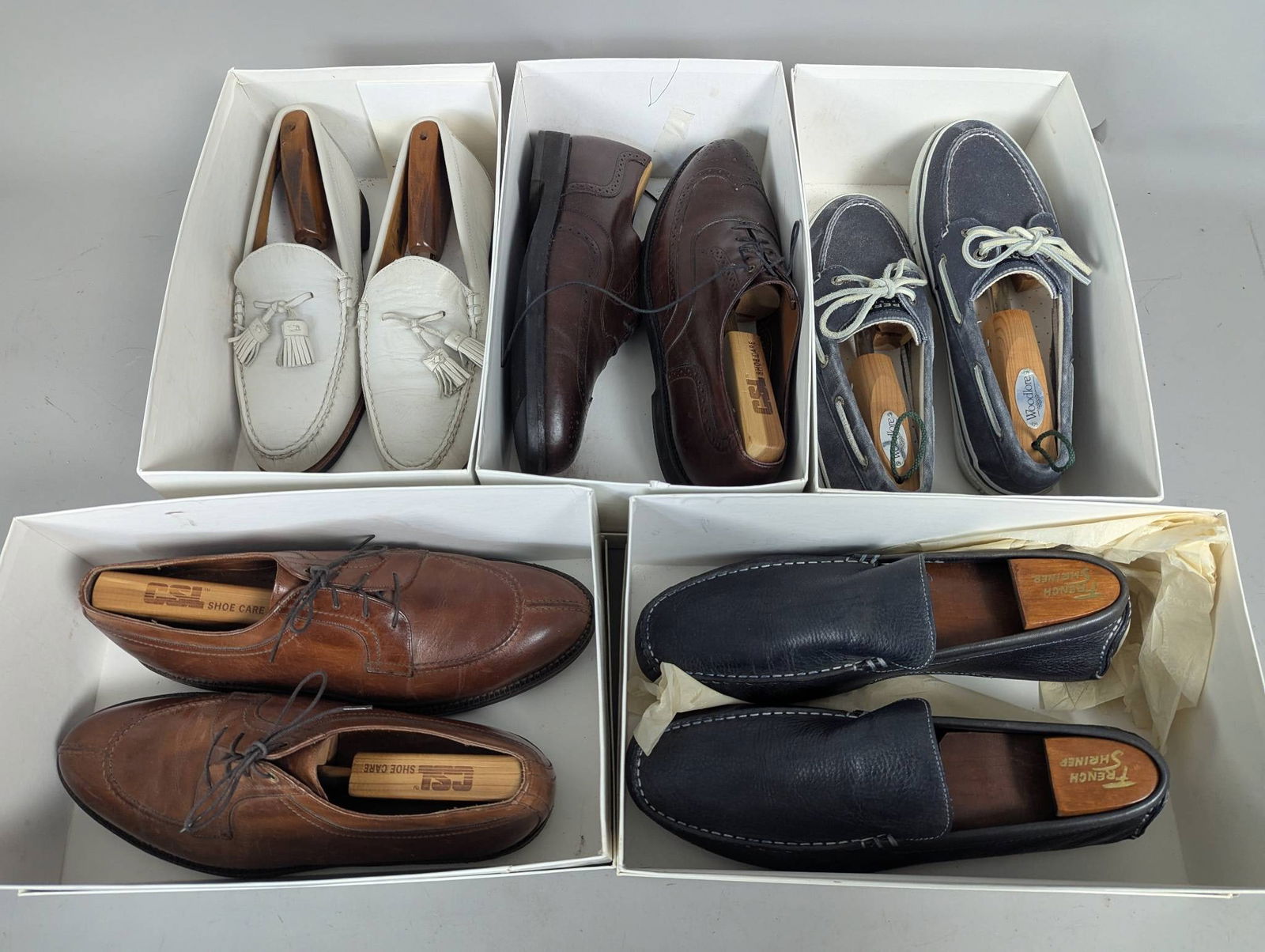 Lot 5 Mens Used Size 10 1 2 and 11 Dress Shoes: Five pairs of used mens dress and casual shoes in sizes 10 1 2 and 11. The collection includes white tasseled loafers with leather soles, brown leather lace-ups with decorative stitching, navy leather