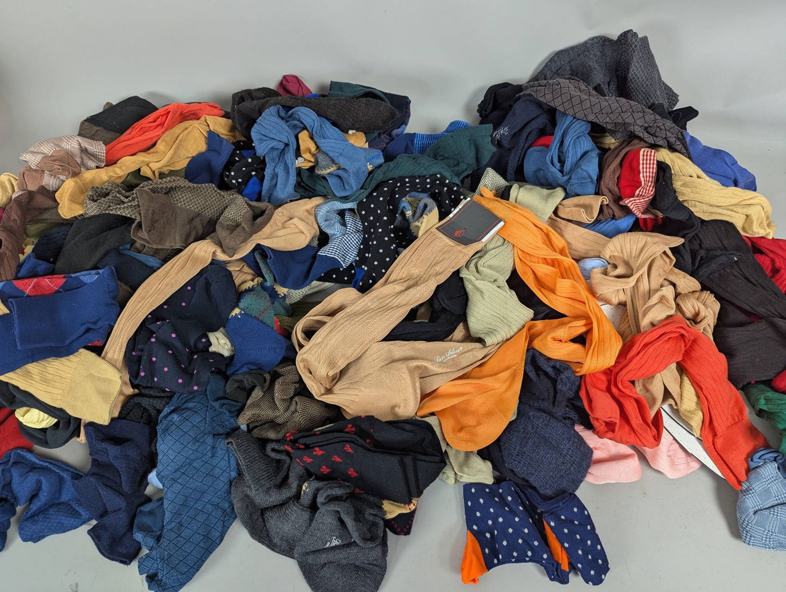 Large Lot Colorful New Socks in Assorted Styles and Colors: New socks featuring various styles and vivid colors. The lot includes a wide range of designs, patterns, and materials suitable for different preferences. Multiple pairs are included, making it ideal