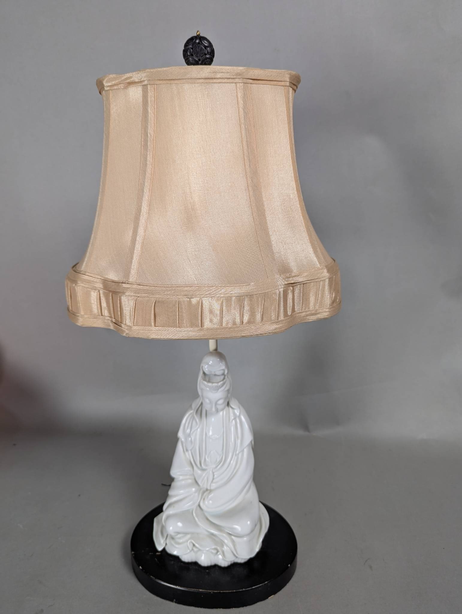Chinese Blanc Art Pottery Kwan Yin Lamp With Fabric Shade: Chinese blanc art pottery lamp featuring a white porcelain figurine of Kwan Yin, also known as Guan Yin, the Bodhisattva of Compassion. The figurine is depicted seated in flowing robes with a serene e
