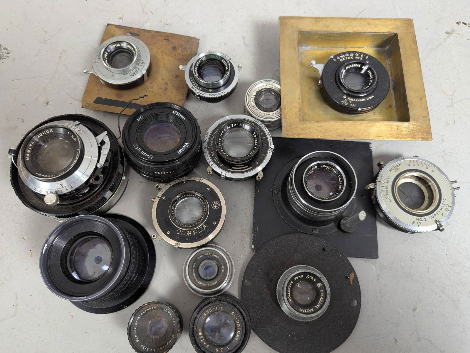 15 Assorted Vintage Camera Lenses: 15 assorted vintage camera lenses from brands such as Carl Zeiss Jena, Vivitar, Hugo Meyer, and Bausch and Lomb. Includes lenses with a variety of focal lengths and apertures, mounted and unmounted pa