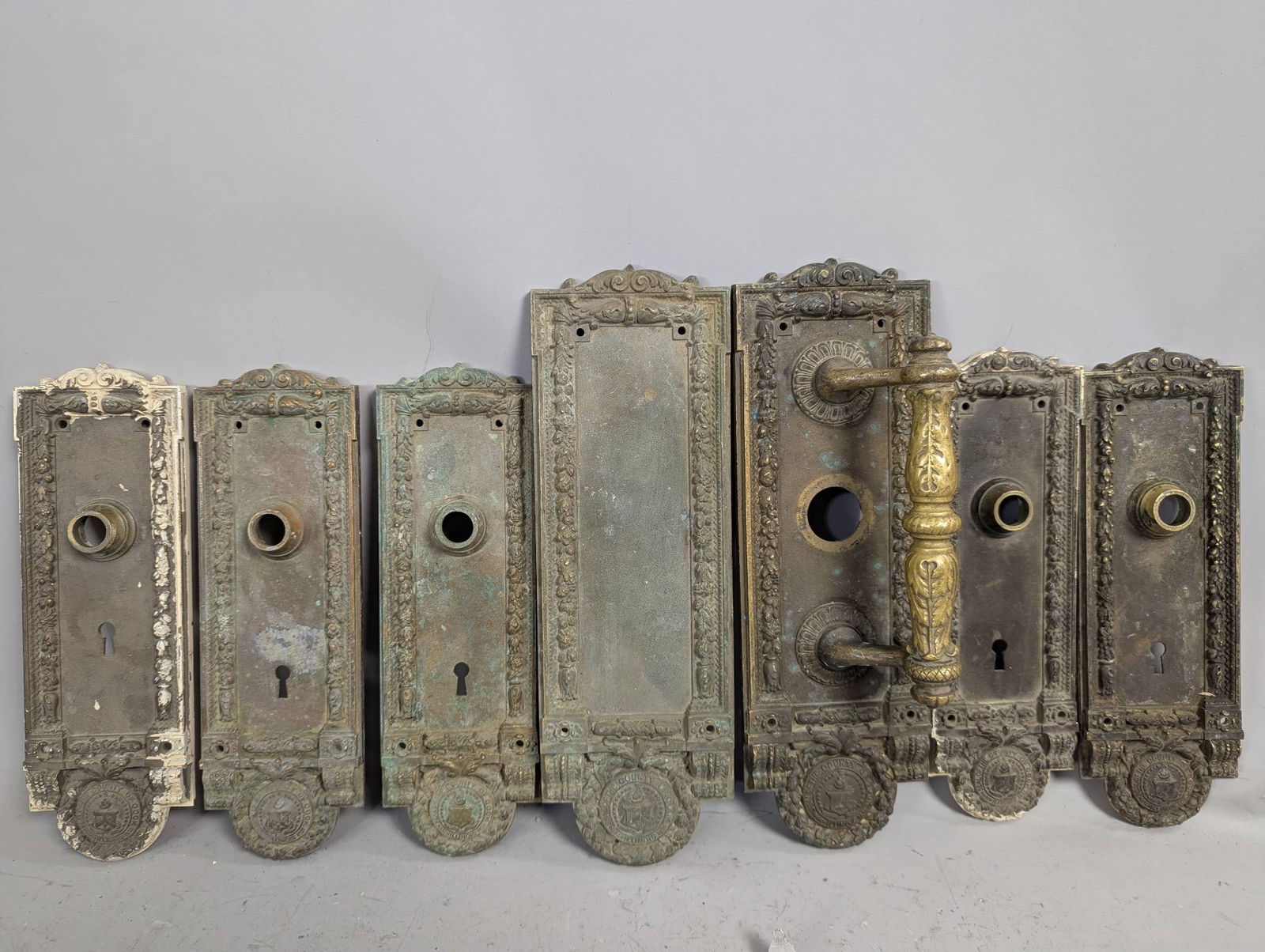 Chicago City Hall Yale and Town MFG Brass Antique Hardware Backplate Escutcheons: Antique brass hardware backplate escutcheons manufactured by Yale and Town MFG, originally from Chicago City Hall. The set includes intricate designs and emblem engravings, representing County of Cook