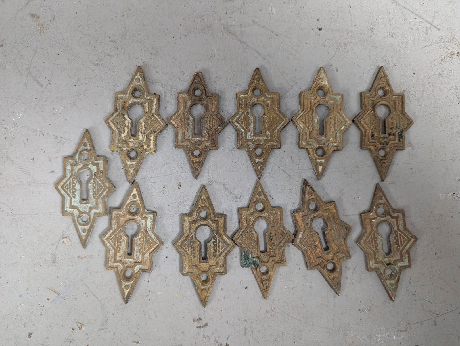 11 Antique Victorian Brass Key Hole Covers: 11 antique Victorian brass key hole covers featuring an ornate design. Each measures approximately 1 1/4 inches high by 2 3/4 inches wide. These are fresh estate finds that need a cleaning. Consistent