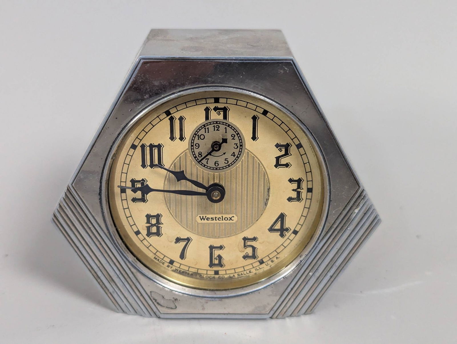 Art Deco Westclox Mantle Clock with Hexagonal Chrome Case: Art Deco Westclox mantle clock featuring a hexagonal chrome case and cream-colored dial with bold, stylized numerals and a subsidiary seconds dial. The clock measures approximately 3 inches high, 4 in