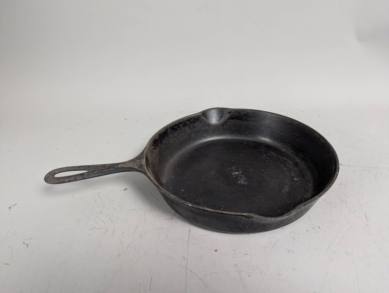 Cast Iron Skillet Number 7 with Handle and Pour Spouts 701: Cast iron skillet measuring 14 1/2 inches high, 11 inches wide, and 2 inches deep. The skillet features the number 7 marking alongside '701' and includes pour spouts on opposite sides for convenience.