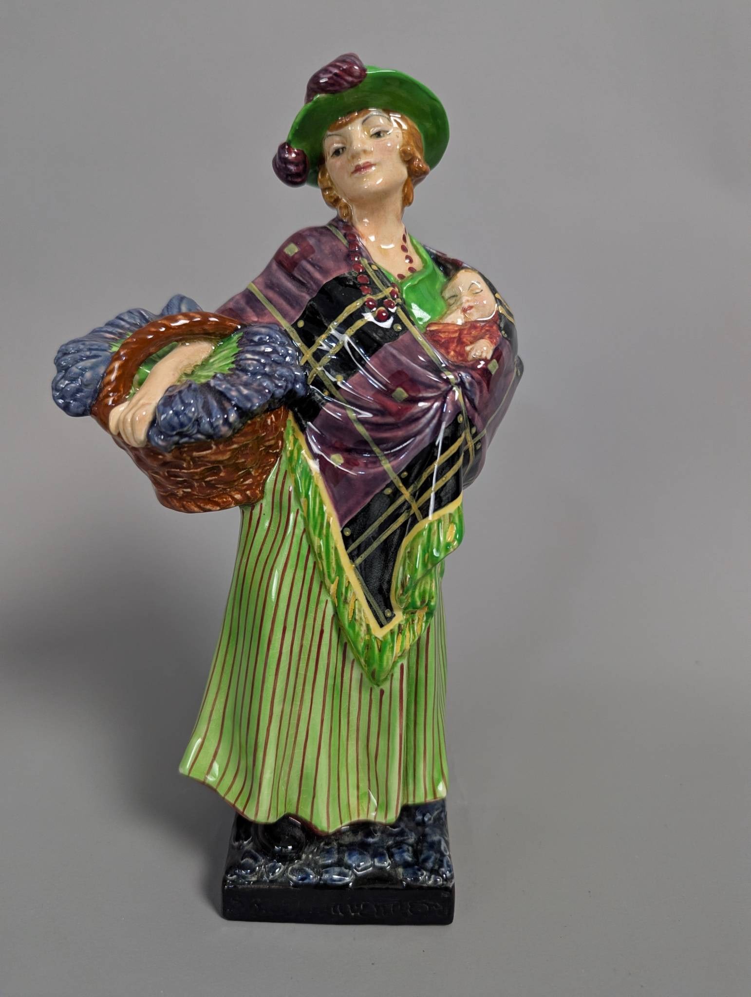 Royal Doulton HN1373 Sweet Lavender Figurine: Royal Doulton Sweet Lavender figurine, model HN1373, crafted in highly detailed polychrome finishes. A striking depiction of a standing woman holding a basket of lavender and a swaddled infant, adorne
