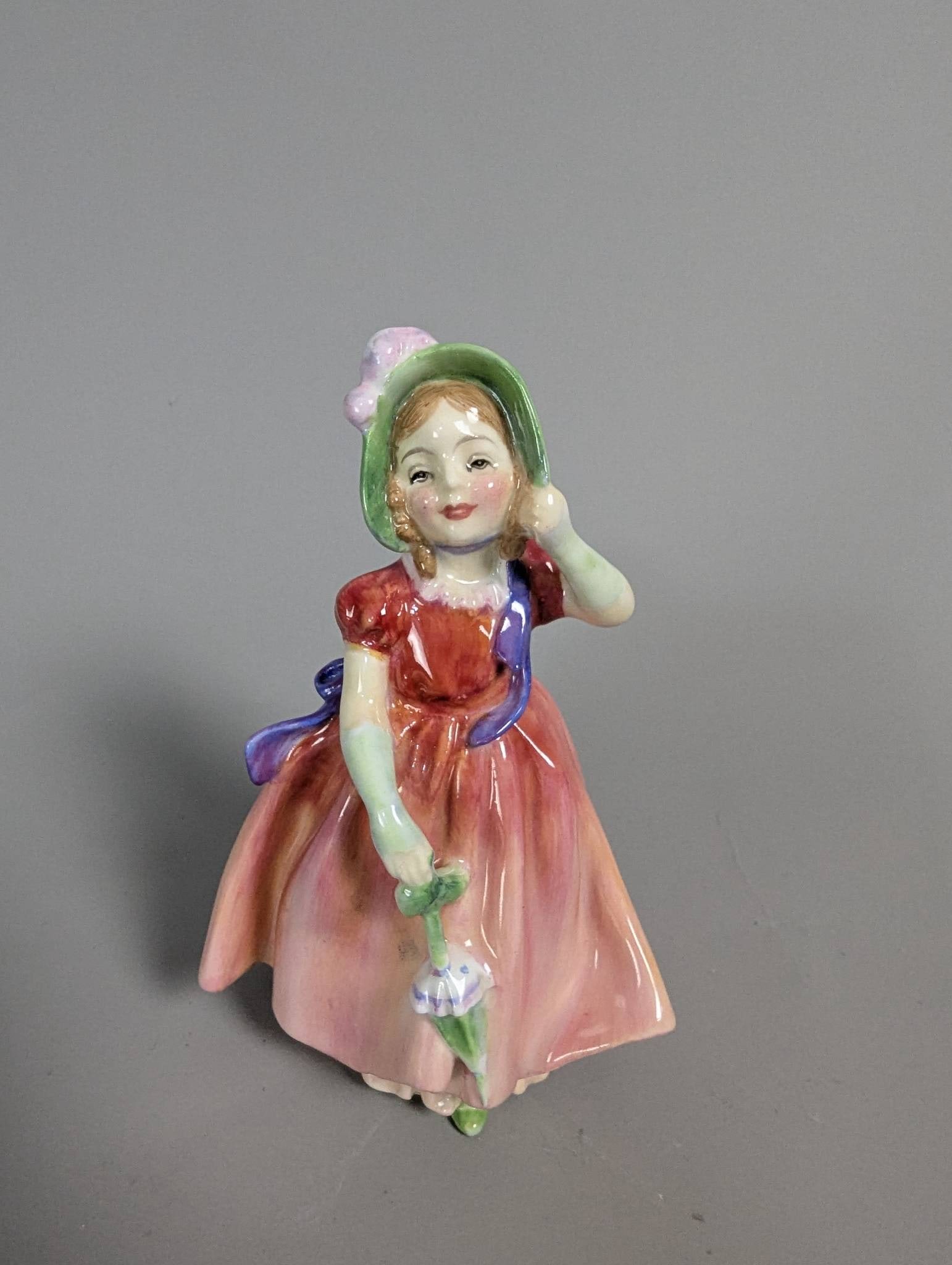 Royal Doulton HN 1842 Babie Figurine in Hand-Painted Porcelain: Royal Doulton figurine titled Babie, model number HN 1842, crafted in porcelain. This piece stands 5 inches high and features hand-painted detailing with vibrant colors. The base bears the Royal Doult