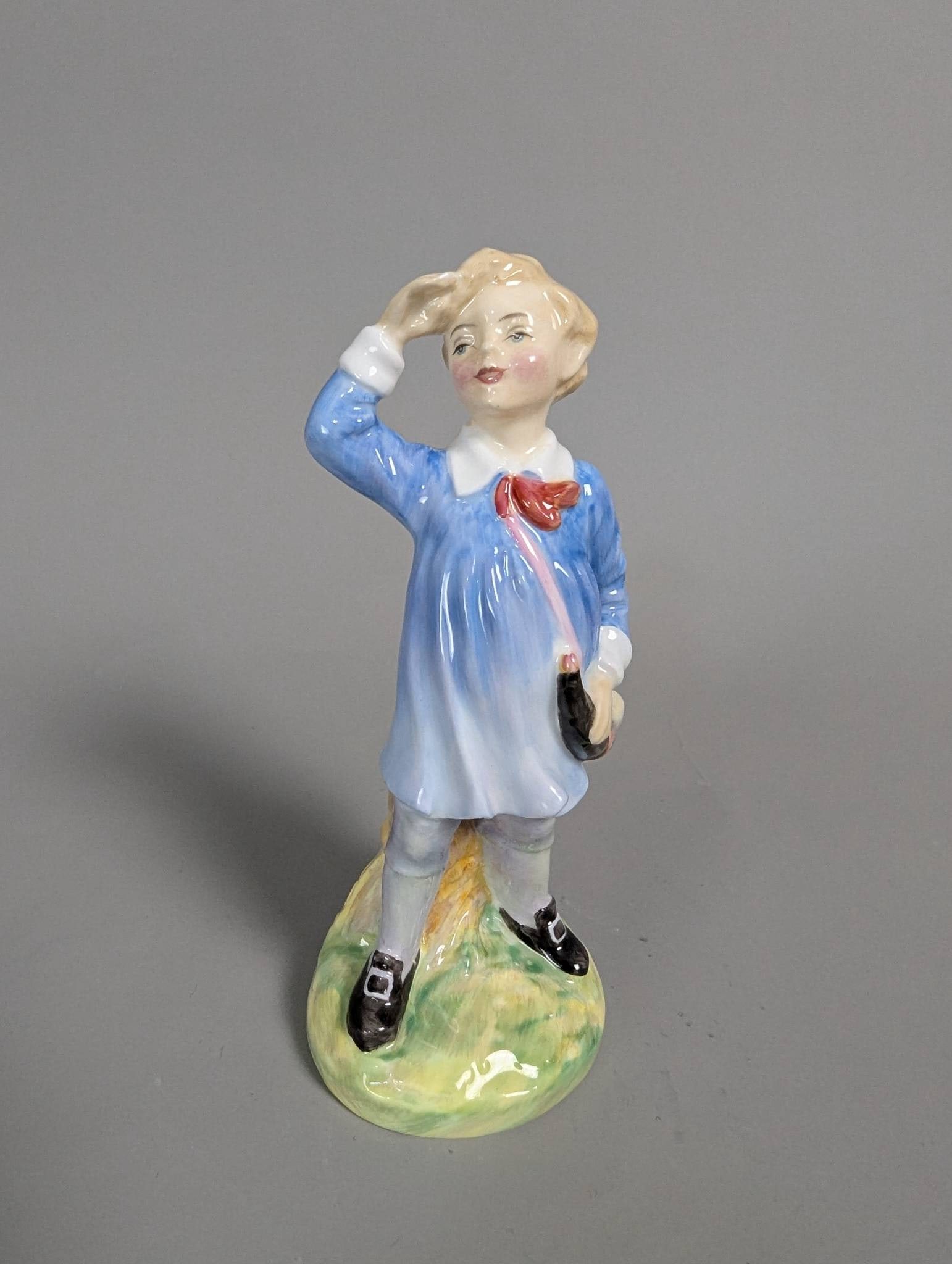 Royal Doulton HN 2062 Little Boy Blue Porcelain Figurine: Royal Doulton porcelain figurine titled Little Boy Blue, model number HN 2062. The piece features a young boy in a blue outfit with red tie, standing on a grassy base and holding a hat. Marked clearly