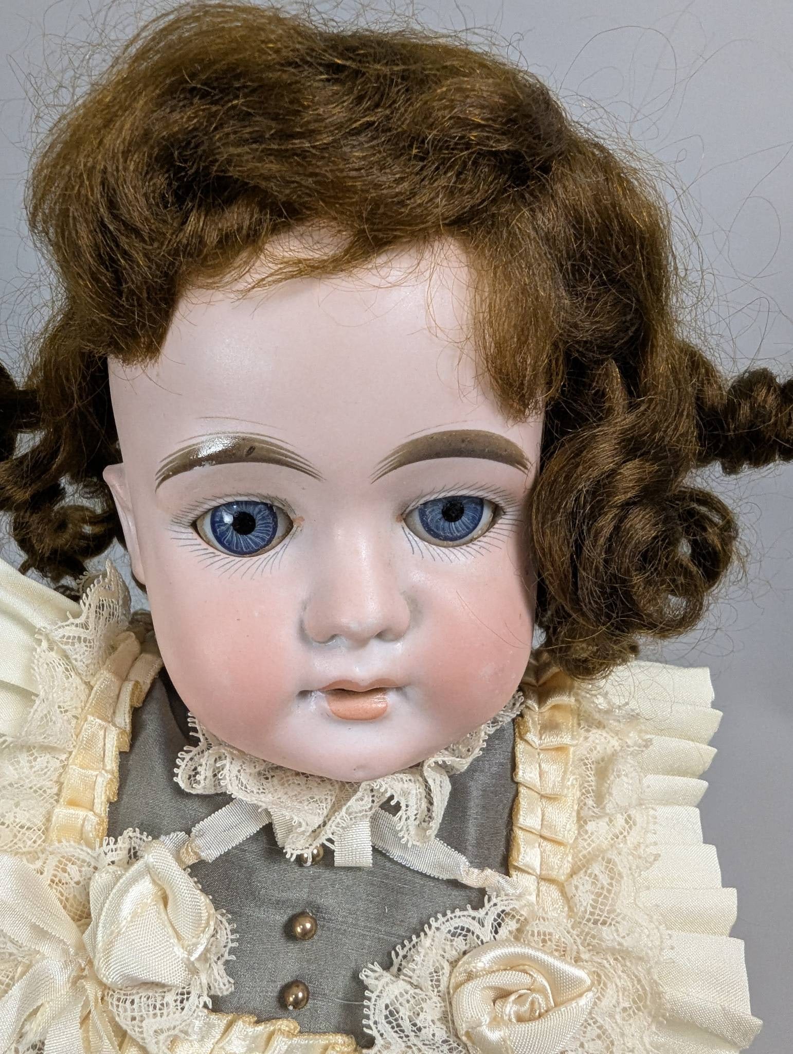 LHK German Doll by Lotte Hummel and Kammer and Reinhardt: LHK German doll attributed to Lotte Hummel and Kammer and Reinhardt. The doll stands 17 inches high, with meticulously detailed features, including hand-painted facial details, blue glass eyes, and cu