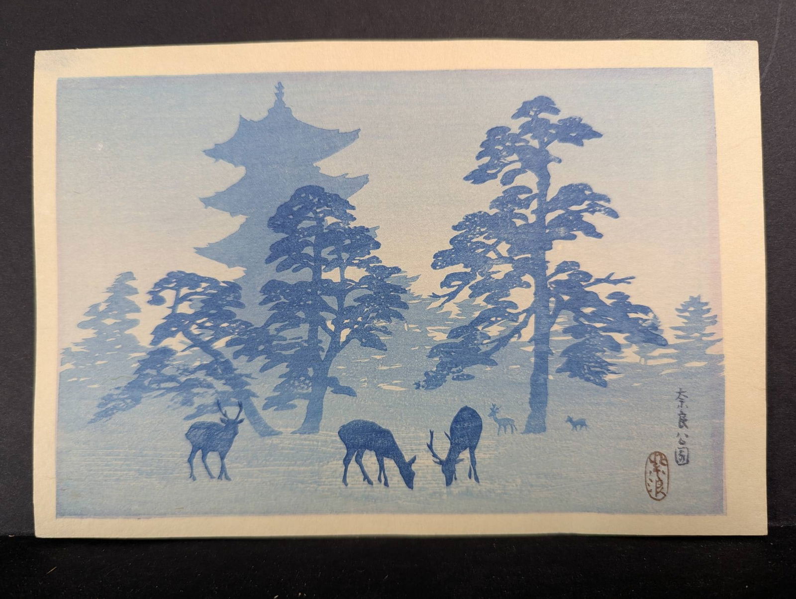 Japanese Woodblock Print Depicting Nara Park by Kasamatsu Shiro c1930â€™s: Japanese woodblock print by Kasamatsu Shiro (1898-1991) depicting deer grazing in Nara Park, with a pagoda and trees forming the backdrop. This work, created around the 1930s, captures a serene landsc