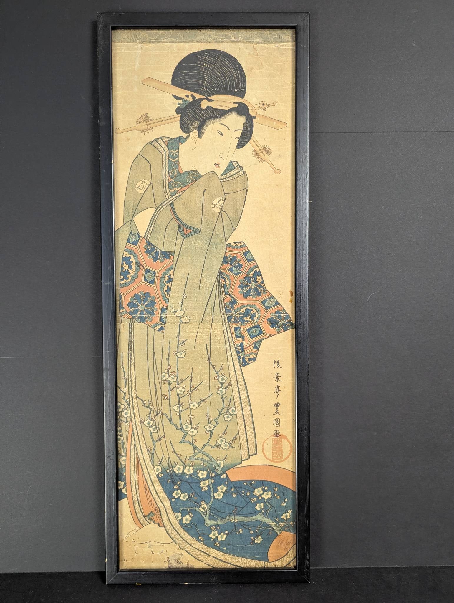 Japanese Woodblock Print by Utagawa Toyokuni III Depicting a Woman Original 19th Century: Japanese woodblock print by Utagawa Toyokuni III (1786-1865) titled Beauty in a Plum Blossom (Kimono Kakemono). Crafted during the 19th century, it features a detailed depiction of a woman adorned in