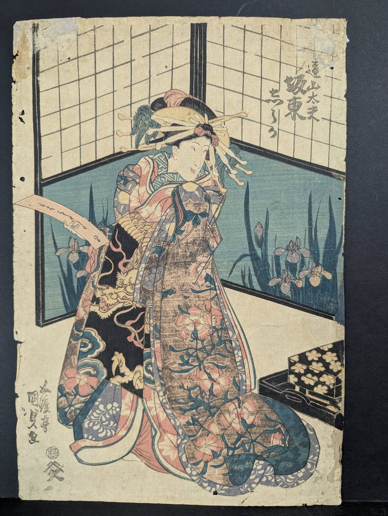 Kunisada Japanese Woodblock Print Depicting Female Figure with Floral Kimono Original 19th Century: Japanese woodblock print attributed to the artist Kunisada, showcasing a detailed portrayal of a female figure dressed in an ornate floral kimono against a domestic interior featuring a shoji screen a