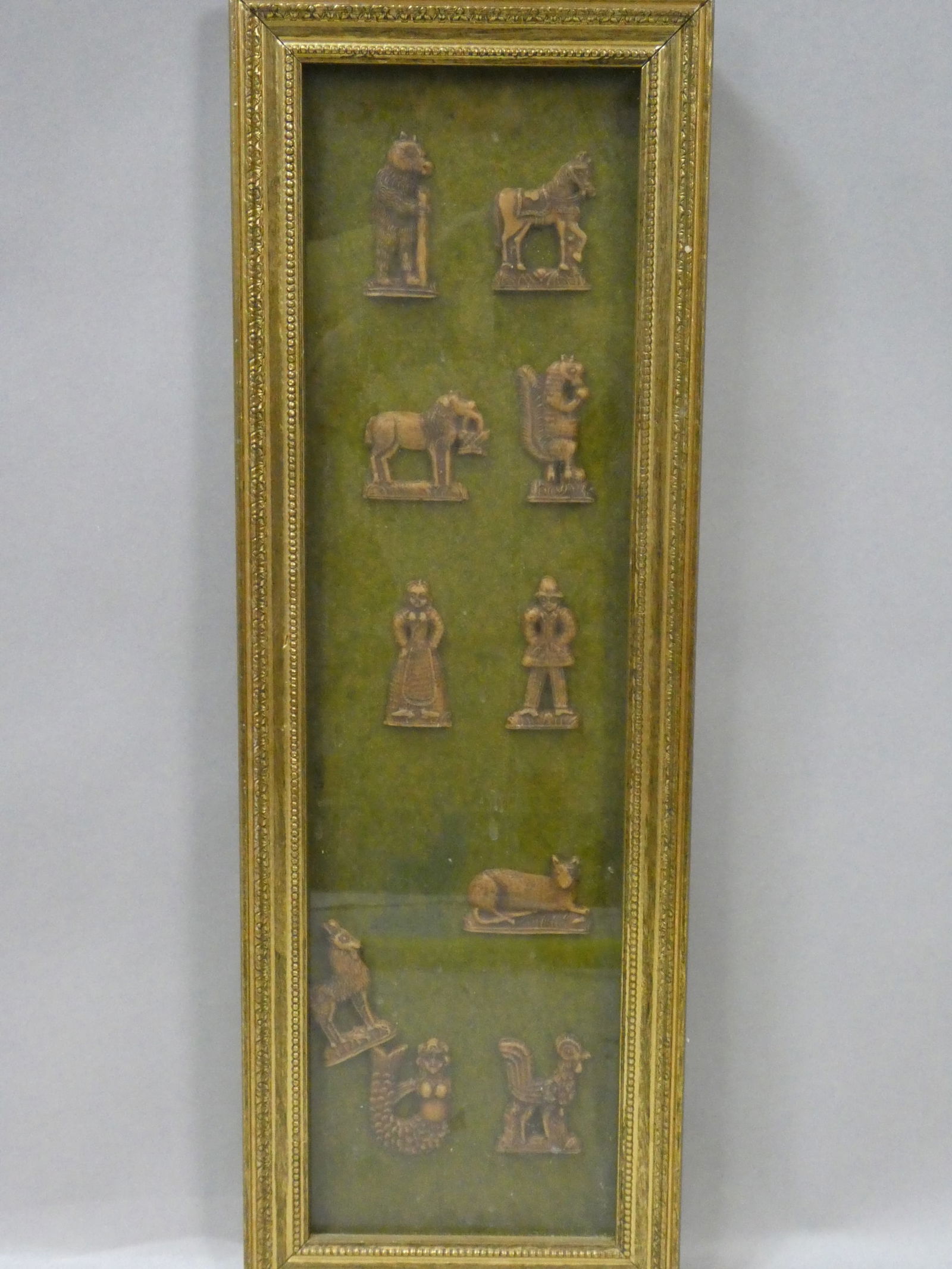 Set 10 c1670 Hungarian Carved Bone Molds: Set 10 c1670 Hungarian Carved Bone Molds framed under glass One is loose in frame, General wear 22 1/2 x 8, 2 to 2 1/2 high molds Shipping: Local pick-up or buyer-arranged welcome. In-house shipping i