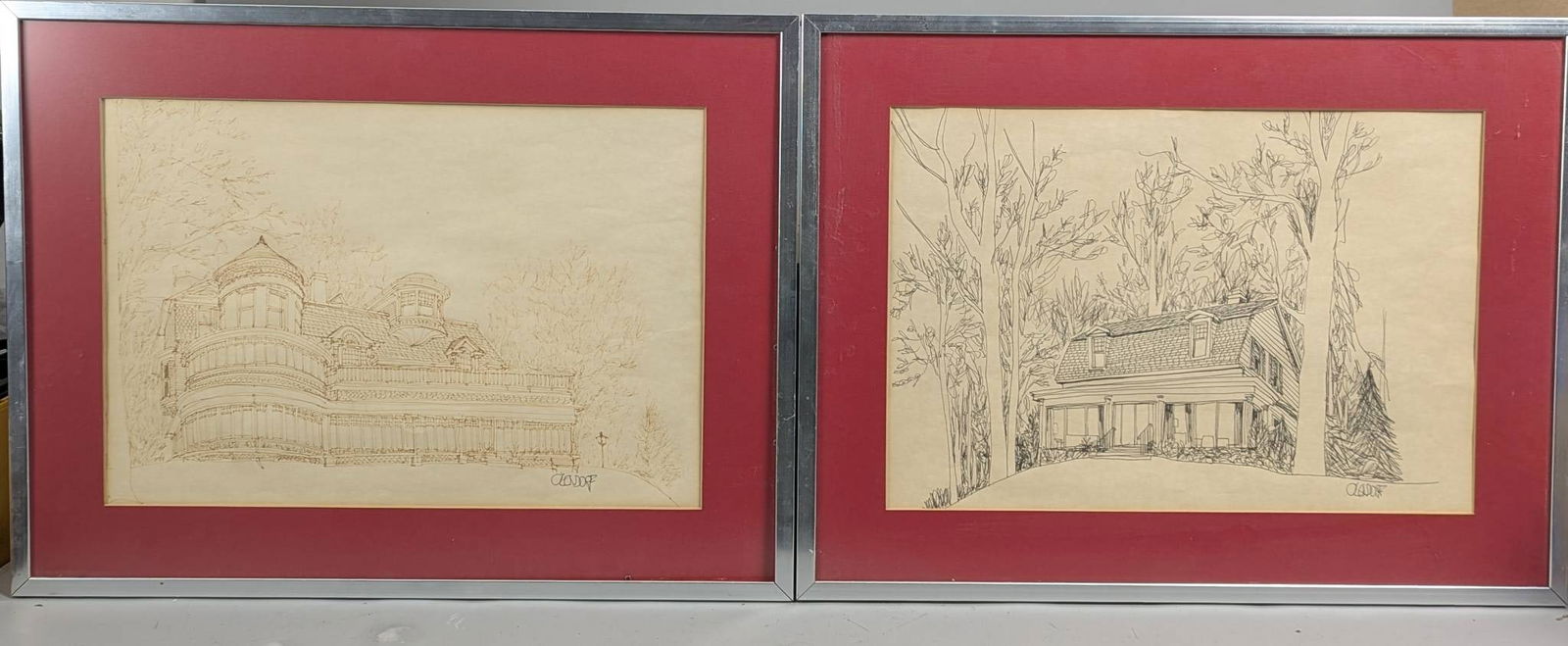 Architectural Drawings by William C Olendorf: Architectural drawings by artist William C Olendorf, featuring intricate depictions of a Victorian-style mansion and a residential home surrounded by trees. Each drawing is framed with red mat borders