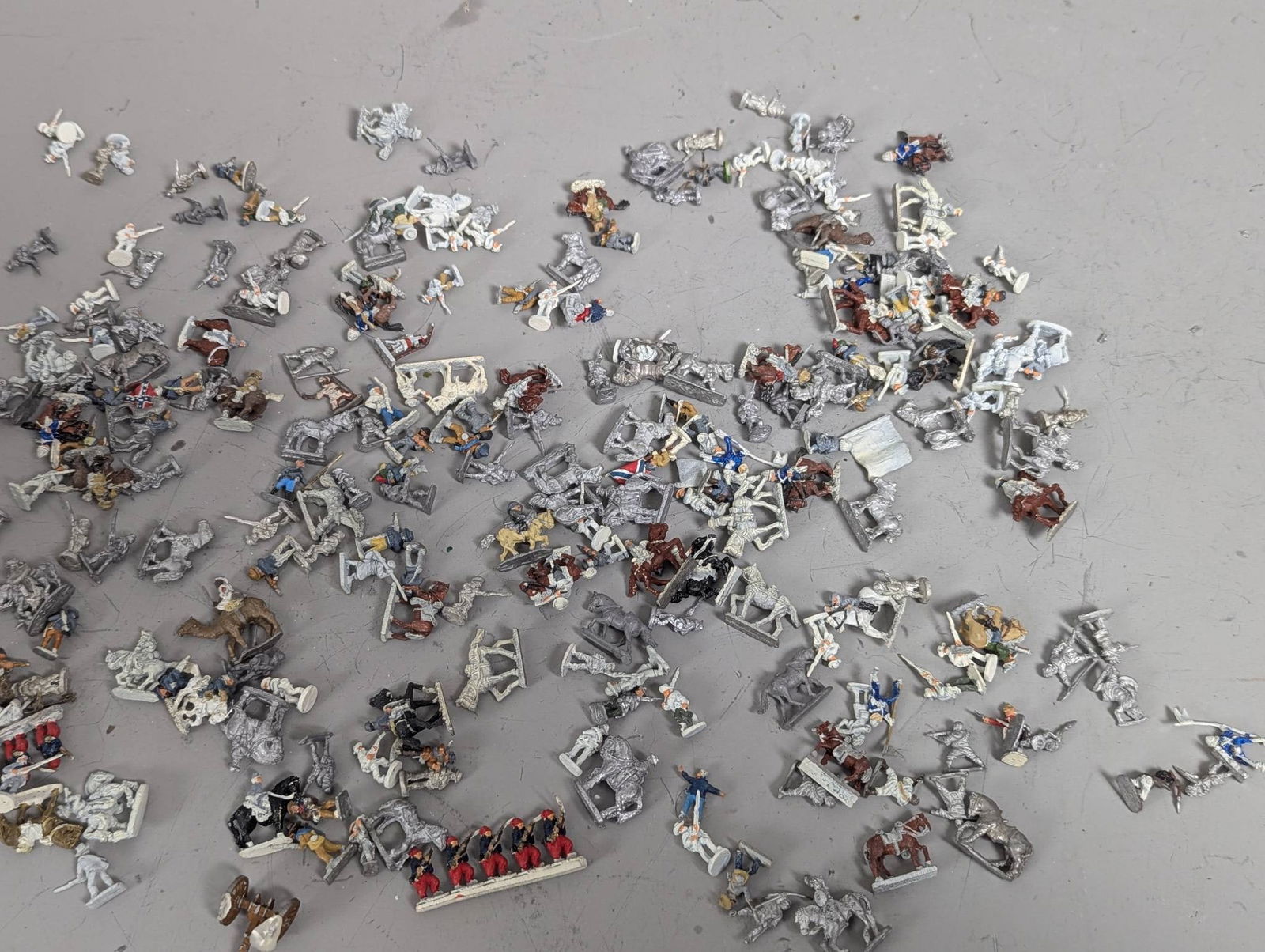 Huge Lot of 20mm Vintage Metal Miniatures in Assorted Themes: Vintage 20mm metal miniatures featuring a variety of figures and themes. The miniatures include soldiers, horses, vehicles, and other items, many of which are painted while others remain in their