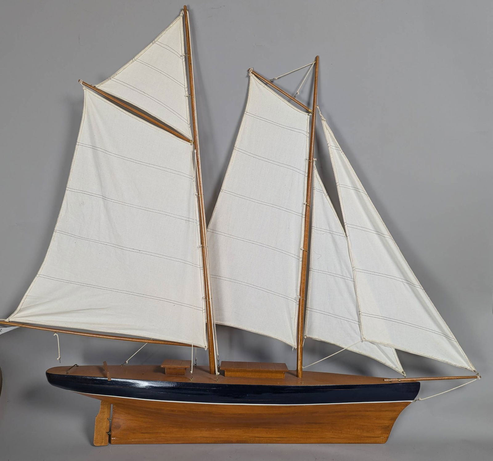 Model of a Two-Masted Schooner Yacht with Dark Blue Hull and White Cloth Sails (1 of 12)