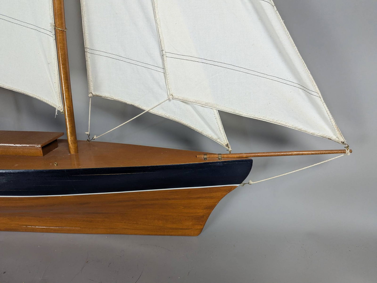 Model of a Two-Masted Schooner Yacht with Dark Blue Hull and White Cloth Sails - 8