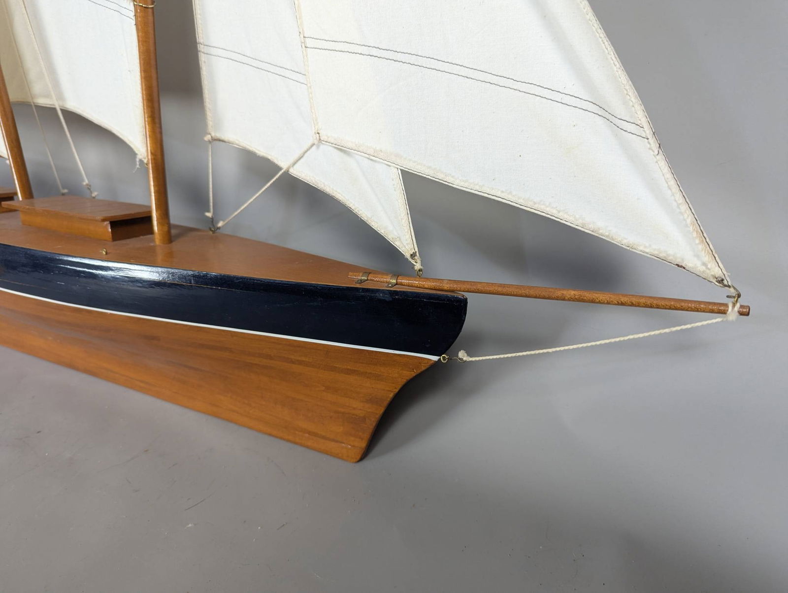 Model of a Two-Masted Schooner Yacht with Dark Blue Hull and White Cloth Sails - 9
