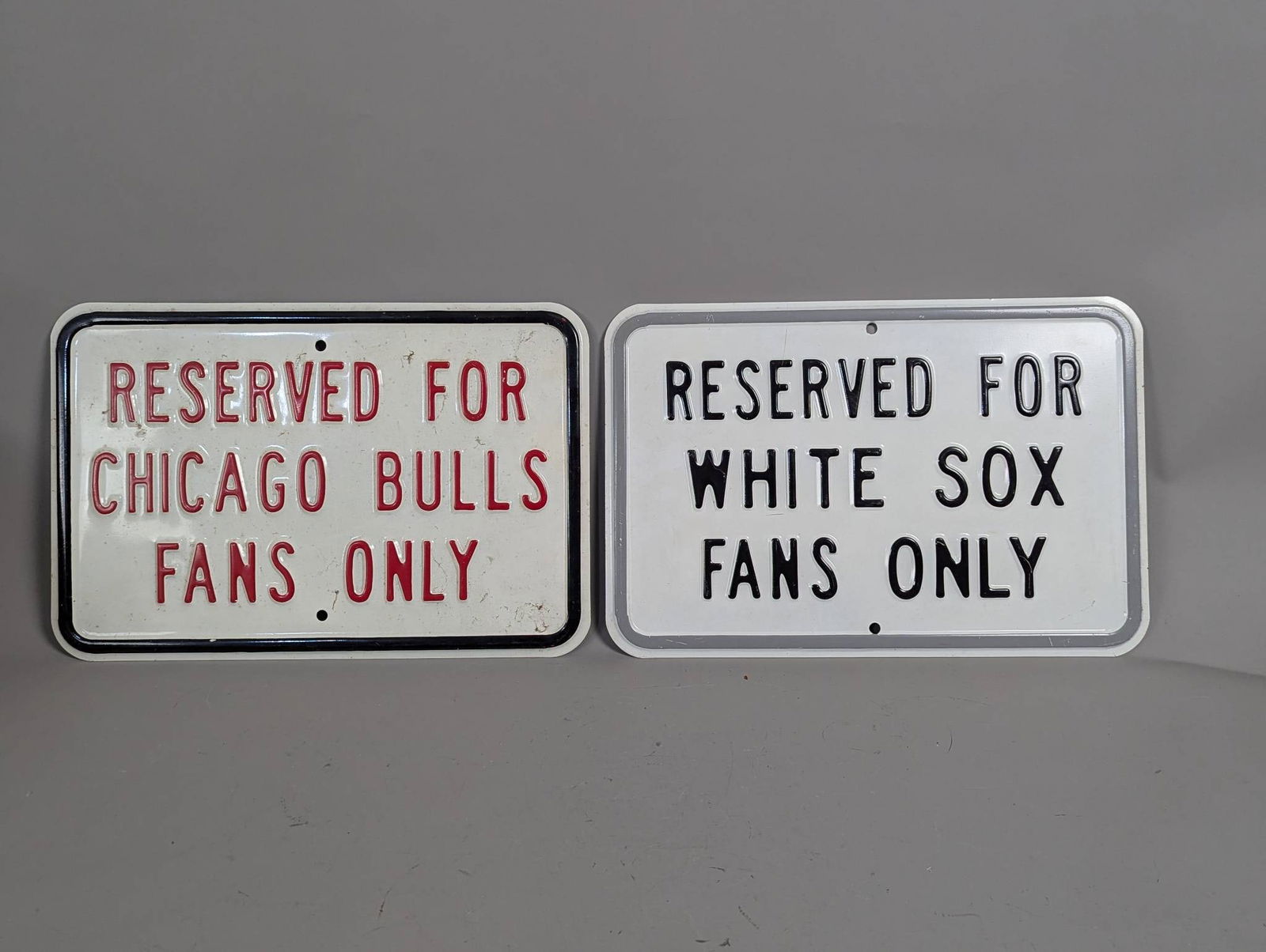 EmbossedÂ Reserved Signs for Fans Only Chicago Bulls & White Sox: Two embossed heavy metal signs, each measuring 18 inches high by 12 inches wide. The signs read Reserved for Chicago Bulls Fans Only and Reserved for White Sox Fans Only. Both signs feature