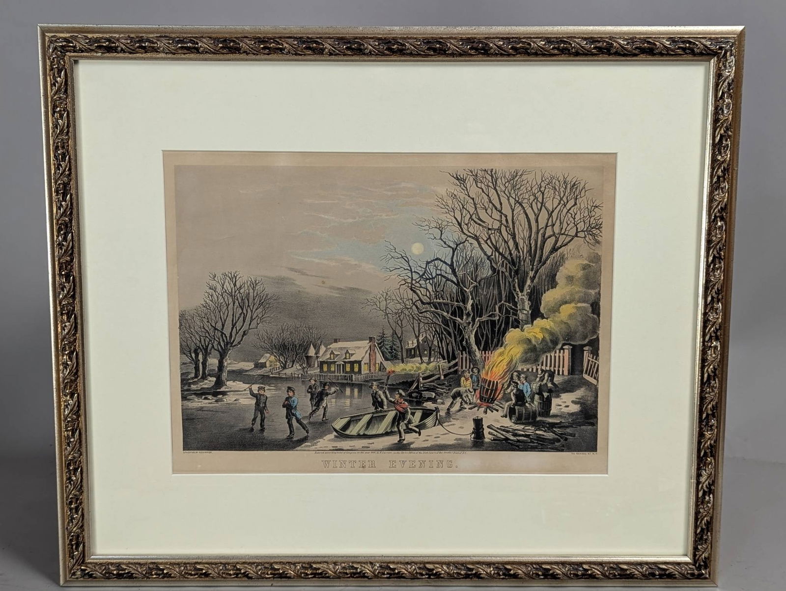 N Currier Lithograph Titled Winter Evening with Ornate Frame: A hand-colored lithograph titled Winter Evening, lithographed and published by N Currier, a renowned 19th-century lithography firm. This artwork measures 15 inches high by 10 1/4 inches wide within