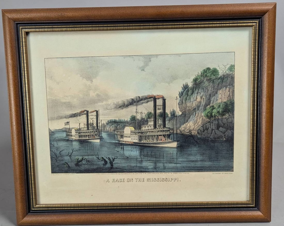 Lithograph Depicting Riverboats on the Mississippi: Framed lithograph titled A Race on the Mississippi, originally published by Currier and Ives. The image dimensions are 12 1/2 inches high by 8 3/4 inches wide, with an overall frame size of 17 3/4