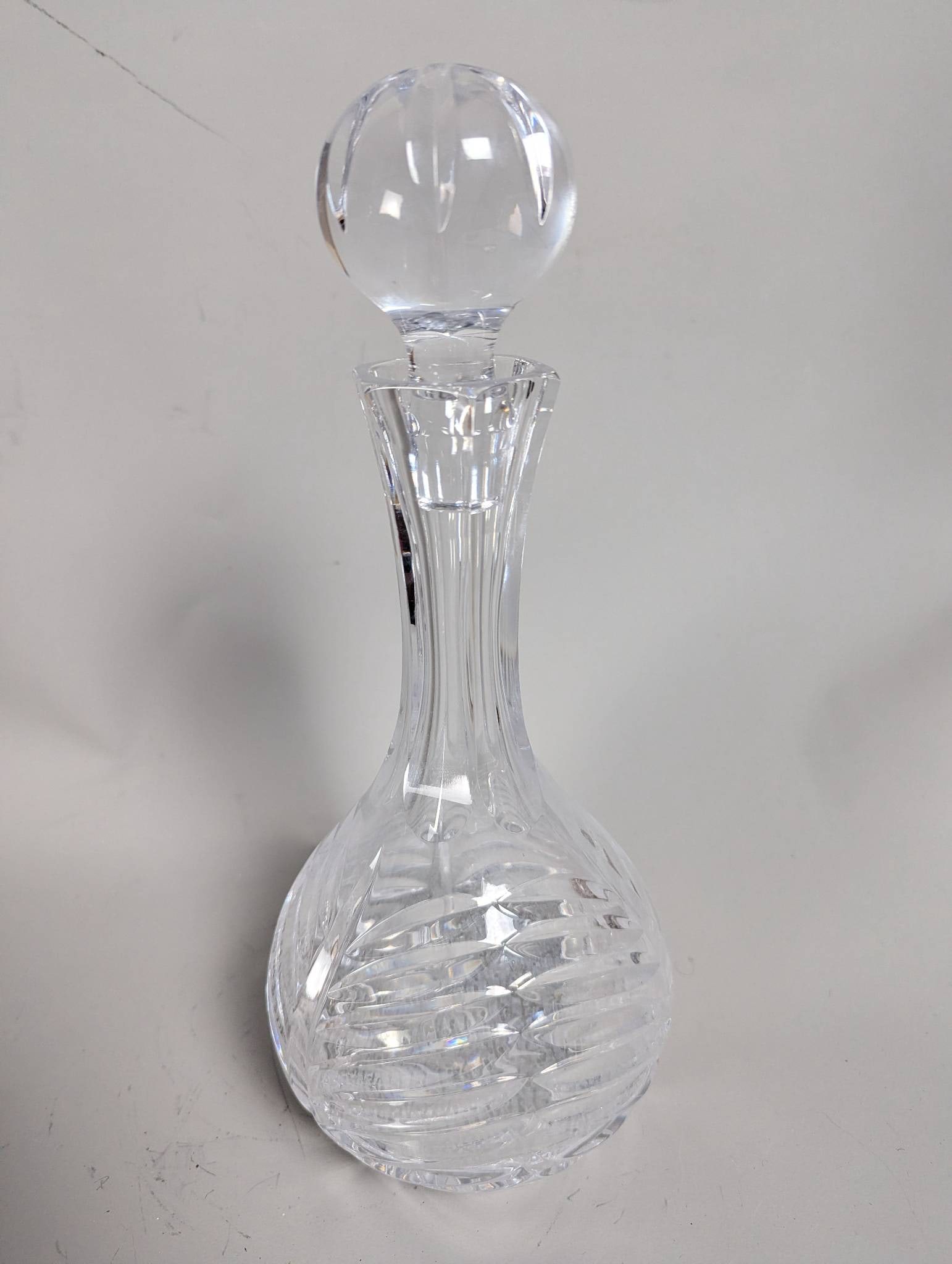 Atlantis Crystal Decanter with Stopper: Atlantis crystal decanter standing 13 inches high with a diameter of 6 inches. Features an intricately cut design on the body and stopper, showcasing excellent craftsmanship. Includes an elegant round