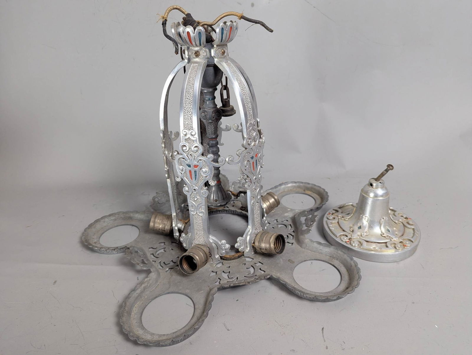 Art Deco Markel Nickel-Plated 5-Light Chandelier Frame with Ceiling Canopy: An Art Deco 5-light down-hanging chandelier frame, attributed to Markel, made of likely nickel-plated aluminum. Measuring 14 inches high and 19 inches wide, the item features ornate, decorative metalw