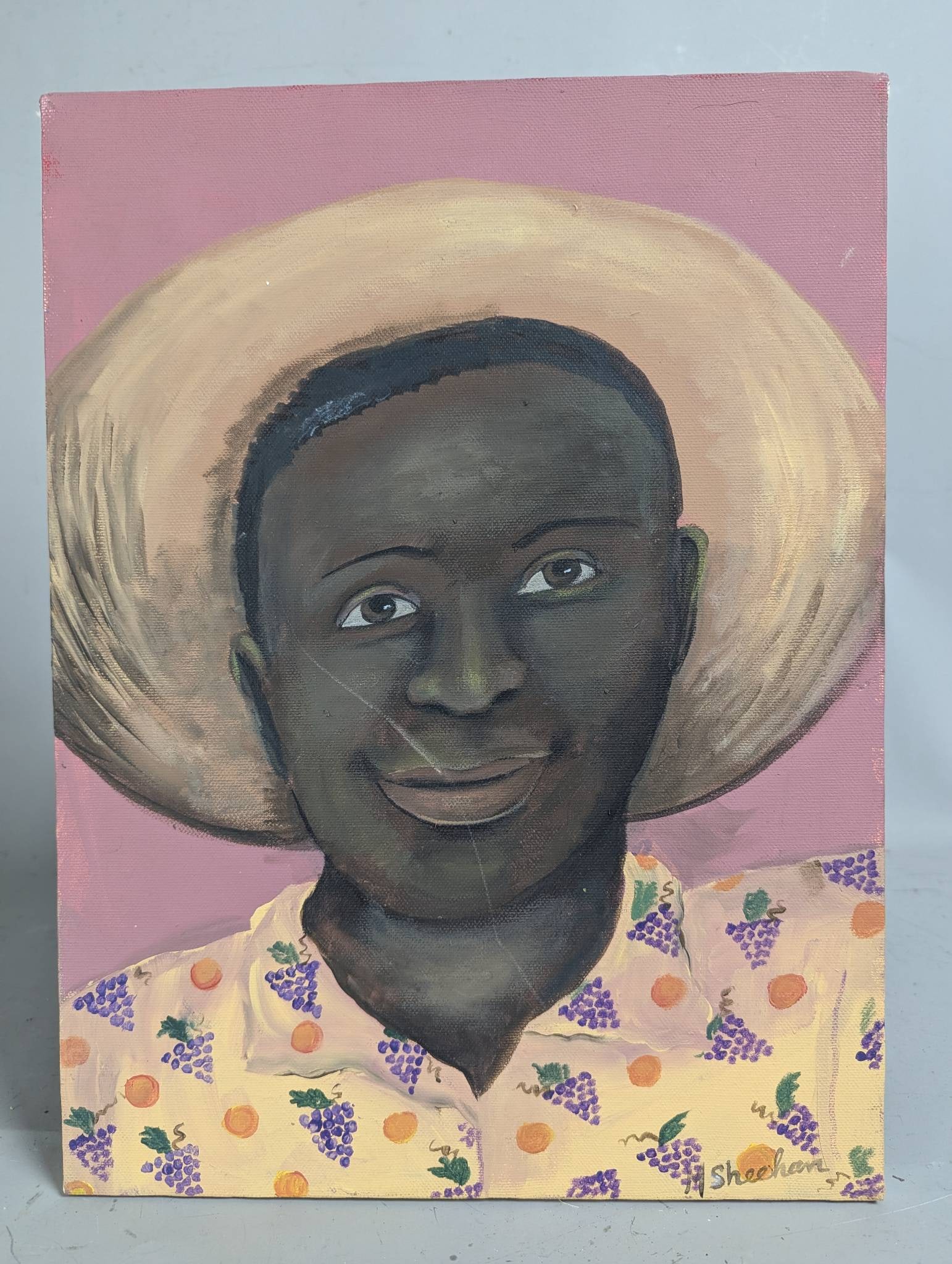 Painting of a Man in a Straw Hat by Sheehan: Acrylic painting on canvas featuring the portrait of a man wearing a straw hat, signed by the artist Sheehan. The subject is depicted against a soft pink background, with vibrant detail in the pattern