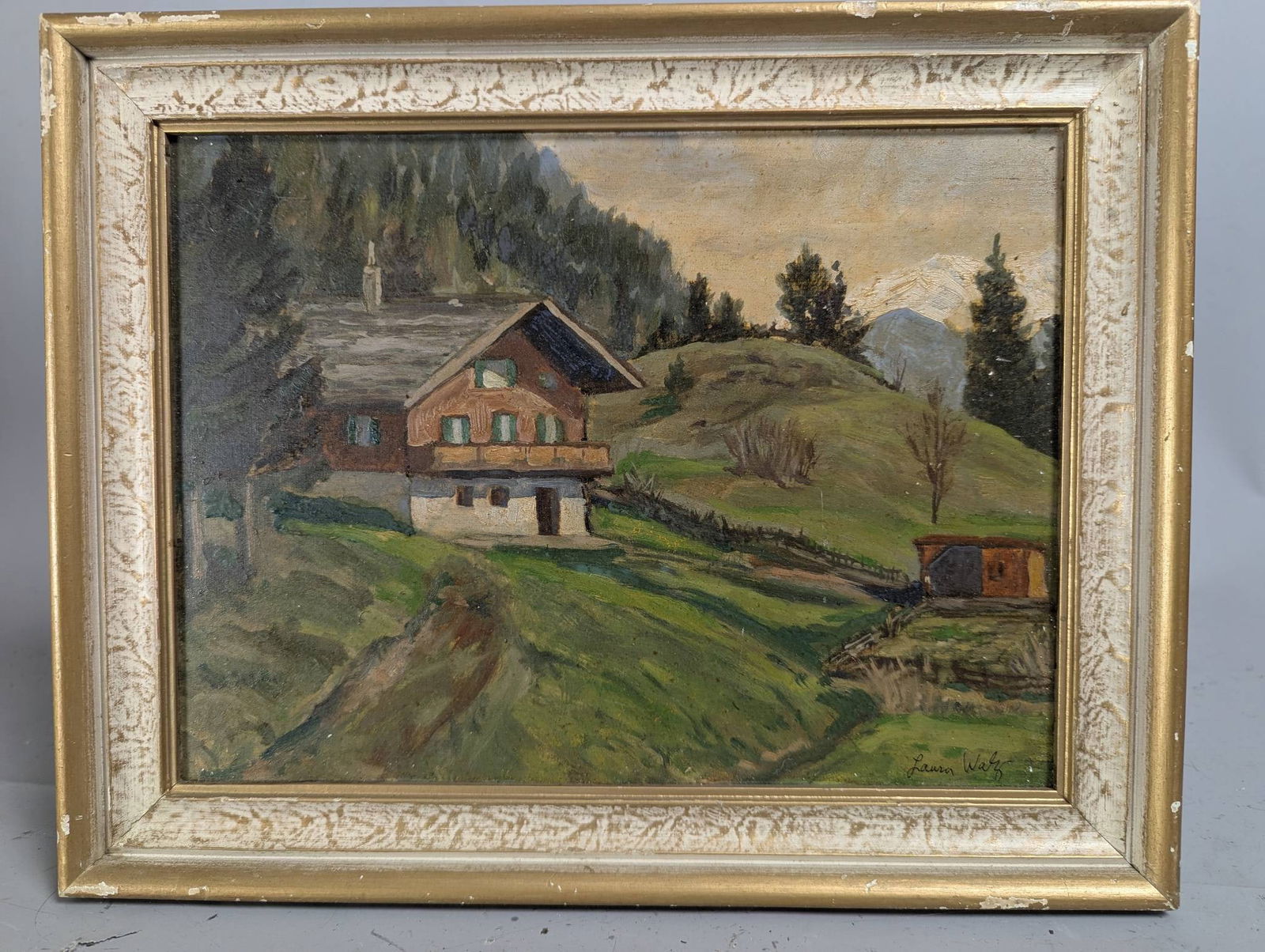 Oil Painting of Alpine Chalet by Laura J K Walz: Oil painting depicting an alpine chalet in a scenic mountain landscape by Laura J K Walz, dated March 1956 and noted to have been created in the Austrian Alps. The artwork measures 12 inches high by 9