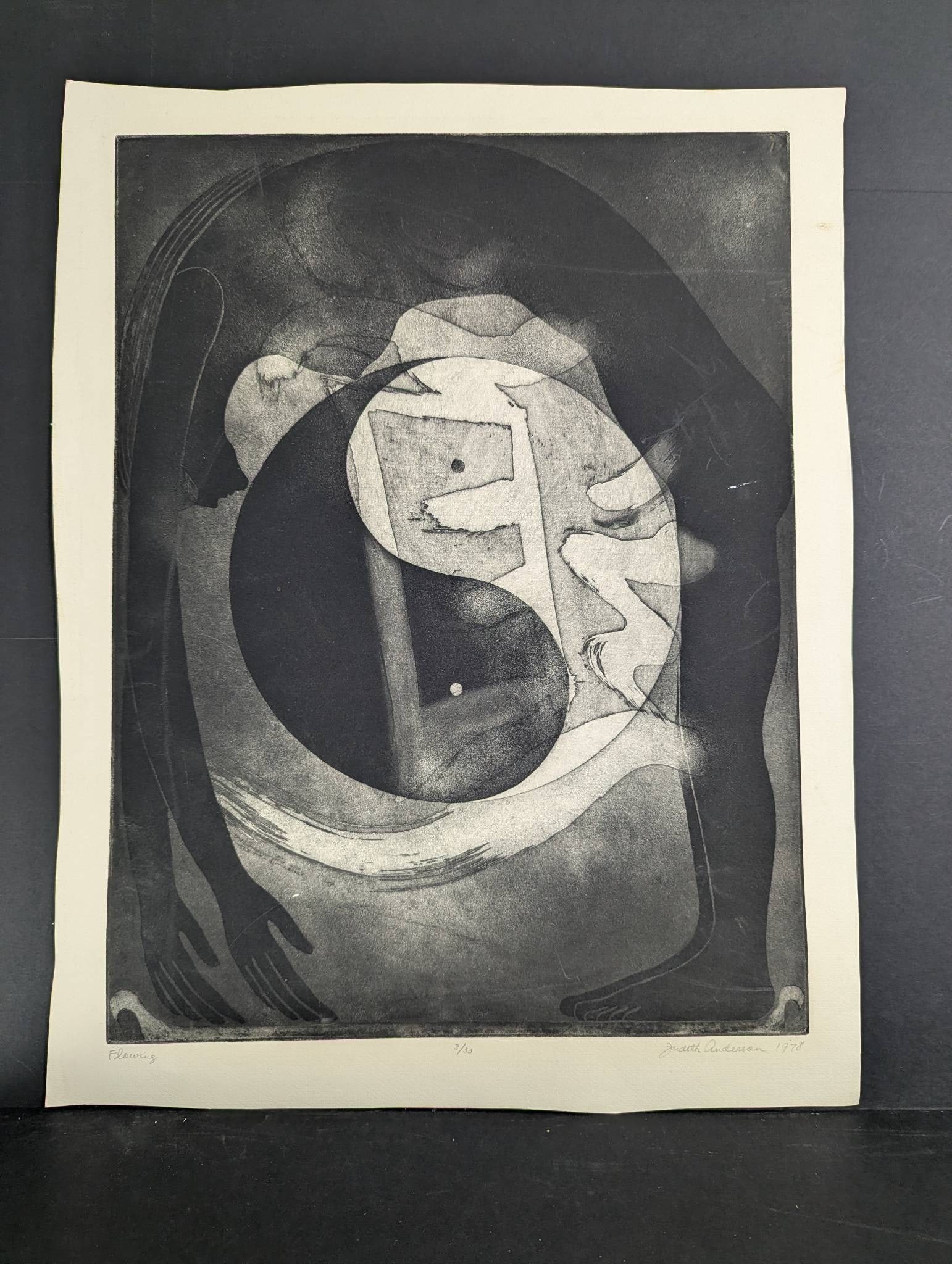 Etching Titled Flowing by Judith Anderson Dated 1978: Etching titled Flowing by artist Judith Anderson, dated 1978. The artwork is printed on paper measuring 21 inches high and 26 inches wide. The image features a dynamic abstract composition with dramat