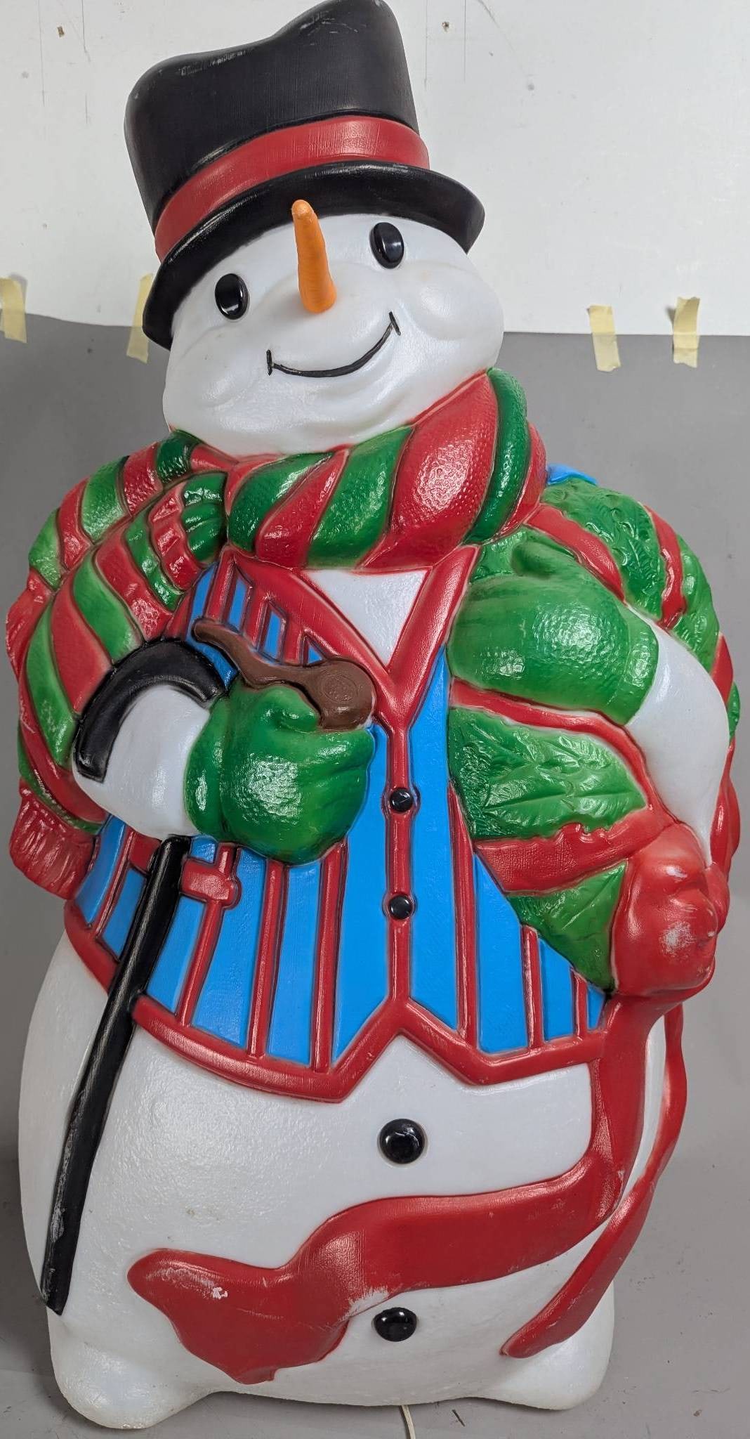 Vintage Frosty Snowman with Cane and Top Hat: Vintage Frosty snowman depiction featuring a cheerful design, vibrant colors, and holiday-themed attire. Frosty is dressed in a striped vest, scarf, and traditional top hat, while holding a cane.