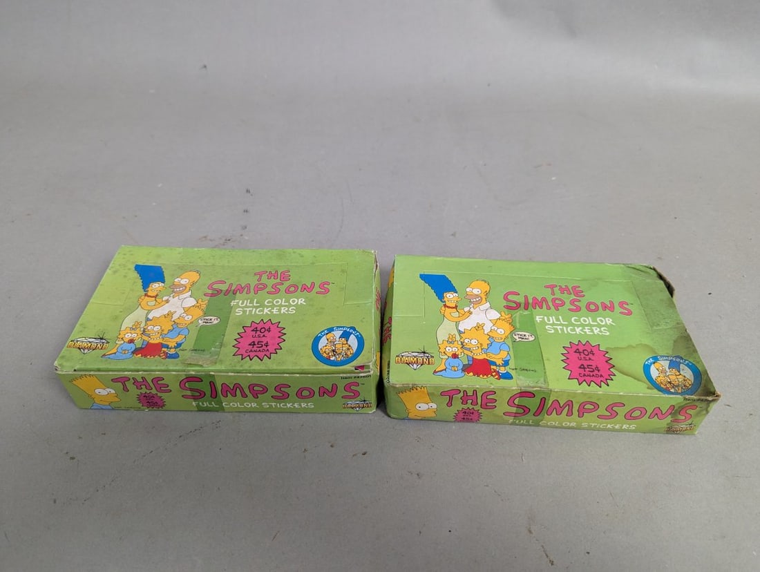 Vintage The Simpsons Full Color Stickers Display Boxes Lot: **Important** Please read below description on how to avoid high shipping costs. This auction features a pair of vintage The Simpsons Full Color Stickers vending boxes measuring 7 x 1 1/2 x 4 1/2.