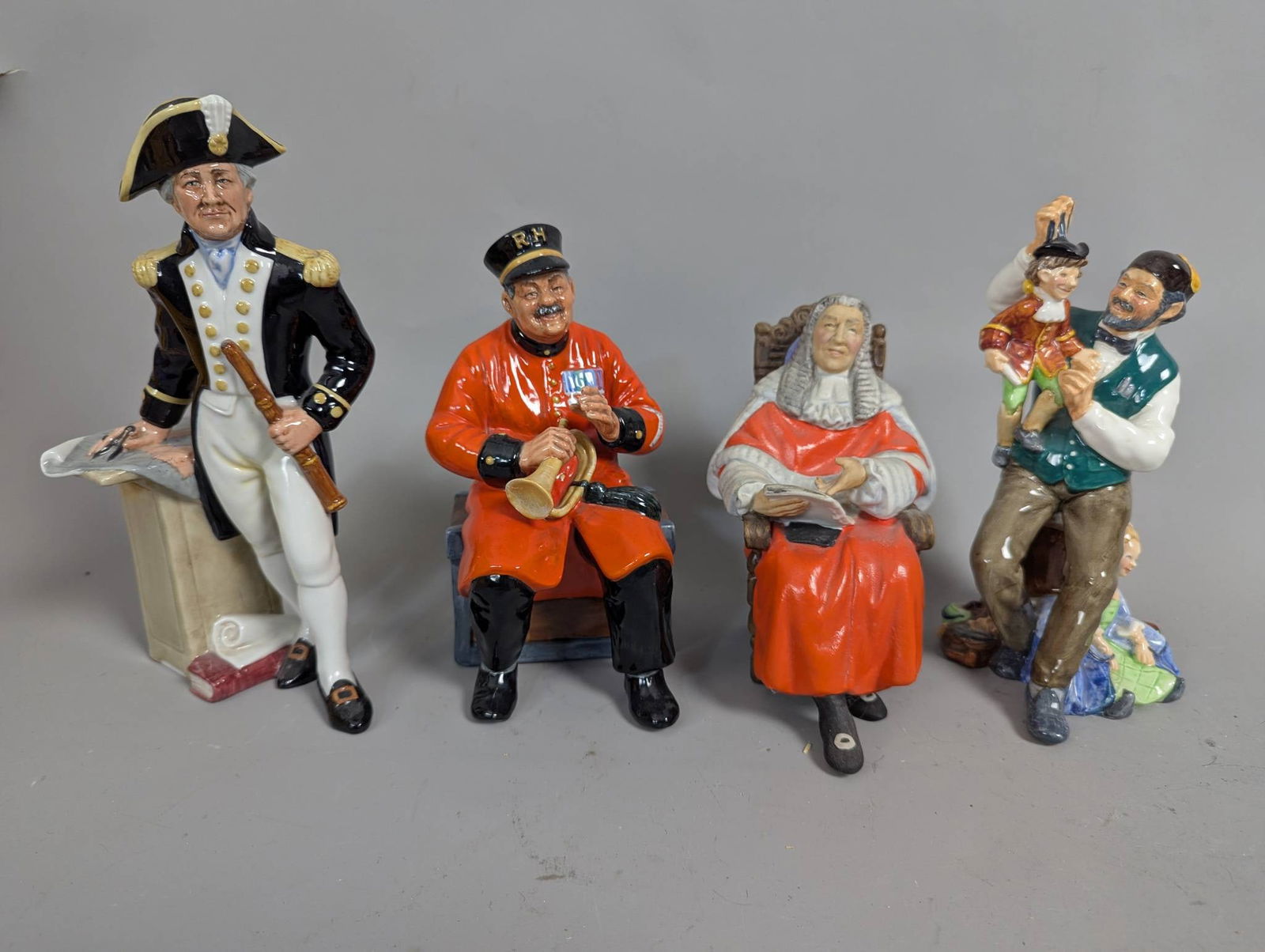 Royal Doulton Figurines Including The Captain and The Puppeteer: **Important** Please read below description on how to avoid high shipping costs. Four Royal Doulton ceramic figurines including The Puppeteer, The Captain, The Judge, and Past Glory. Each figure