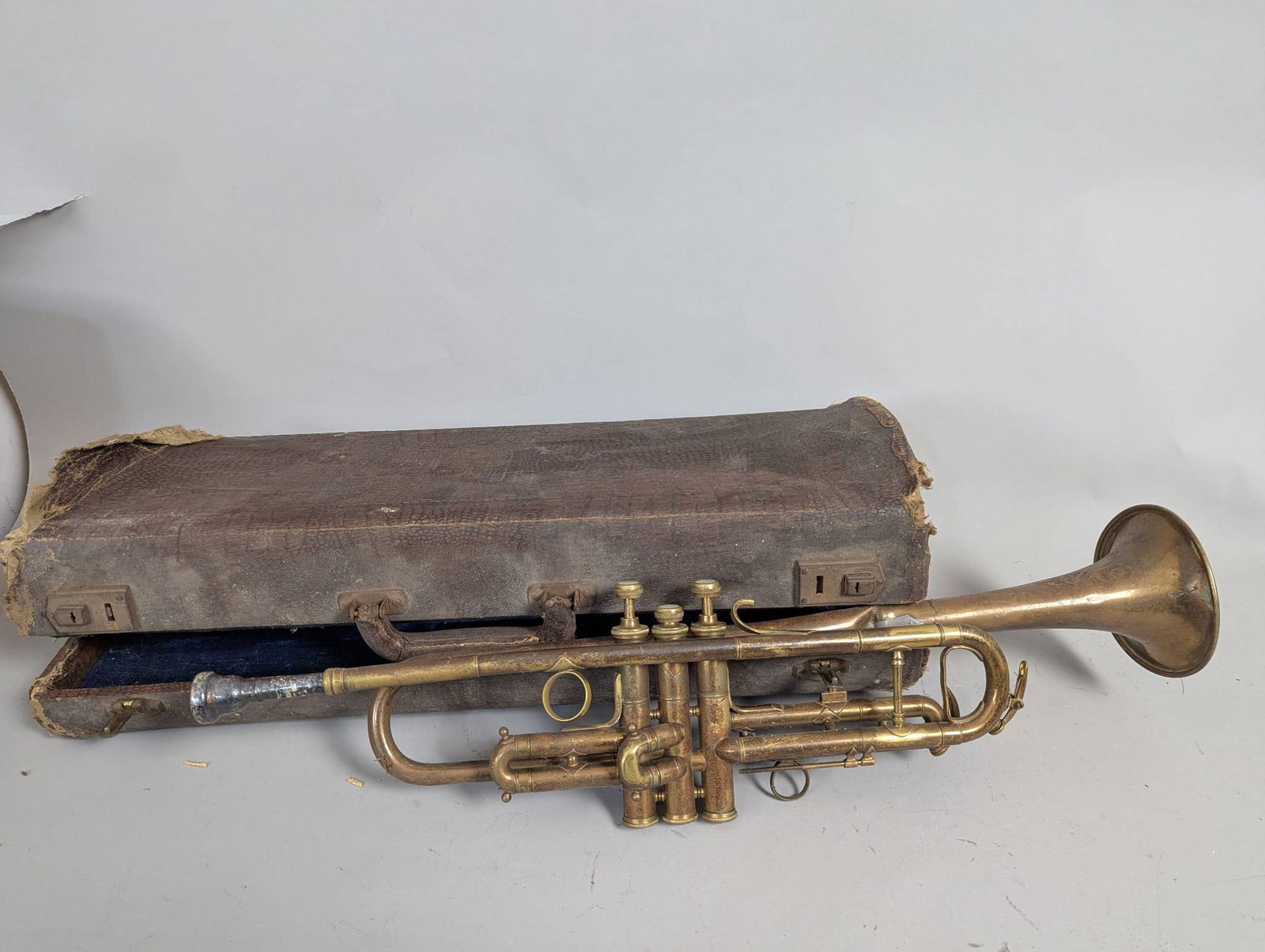 Antique Brass Trumpet with Silver Plate Mouthpiece and Case: **Important** Please read below description on how to avoid high shipping costs. Antique brass trumpet accompanied by a silver plate mouthpiece and a worn carrying case. The case measures 22 inches hi