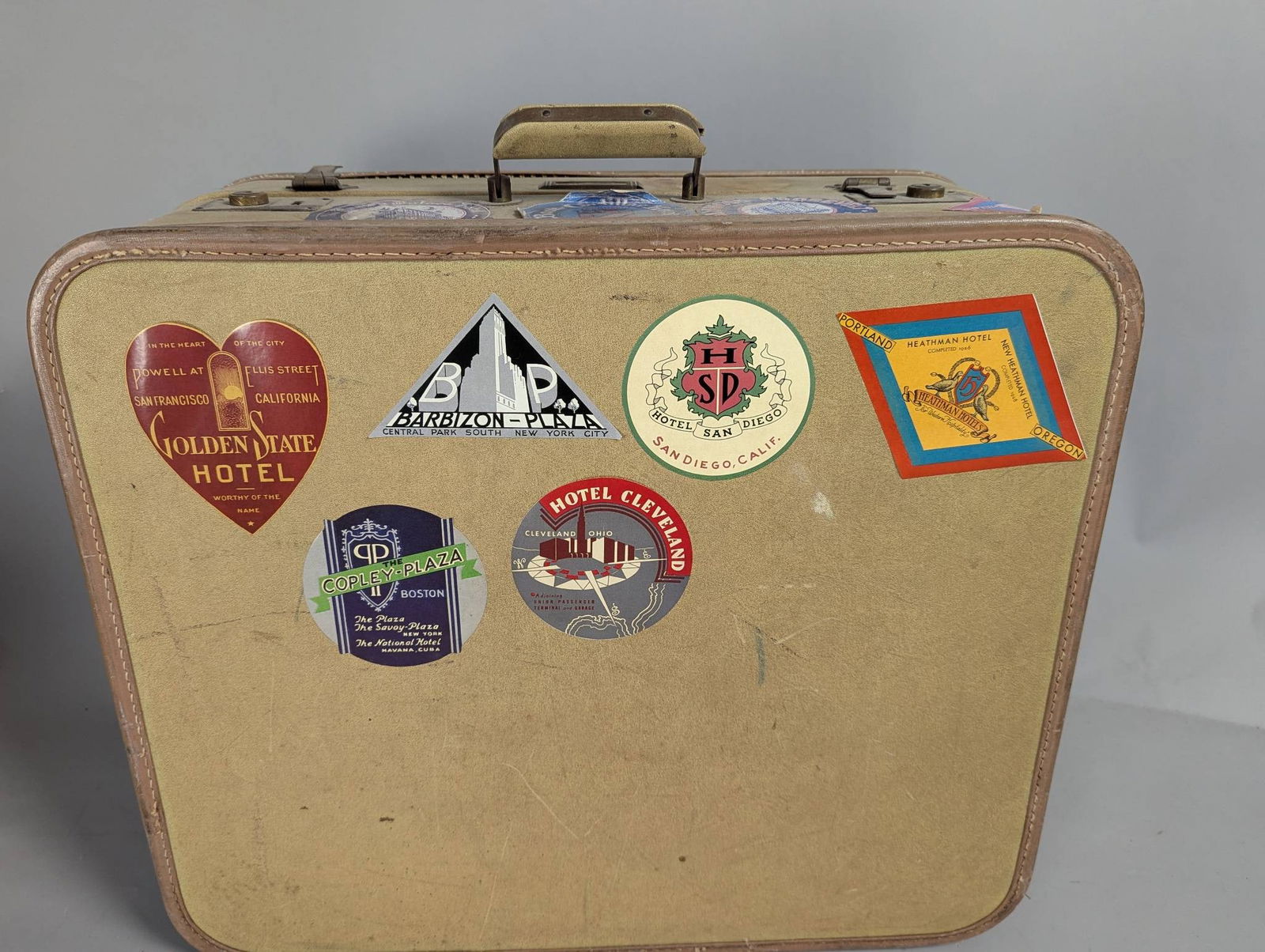 Vintage Travel Suitcase with Hotel Stickers: **Important** Please read below description on how to avoid high shipping costs. A vintage suitcase adorned with various hotel stickers, including ones from Golden Gate Hotel in San Francisco, Barbizo
