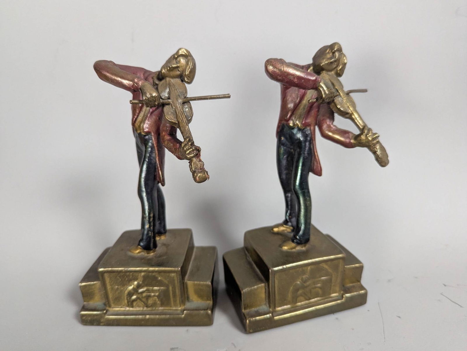 Armor Bronze Huck Finn Bookends with Bronze-Clad Finish: **Important** Please read below description on how to avoid high shipping costs. Vintage Armor Bronze Huck Finn bookends depicting a figure, likely Huckleberry Finn, playing a violin. Manufactured by