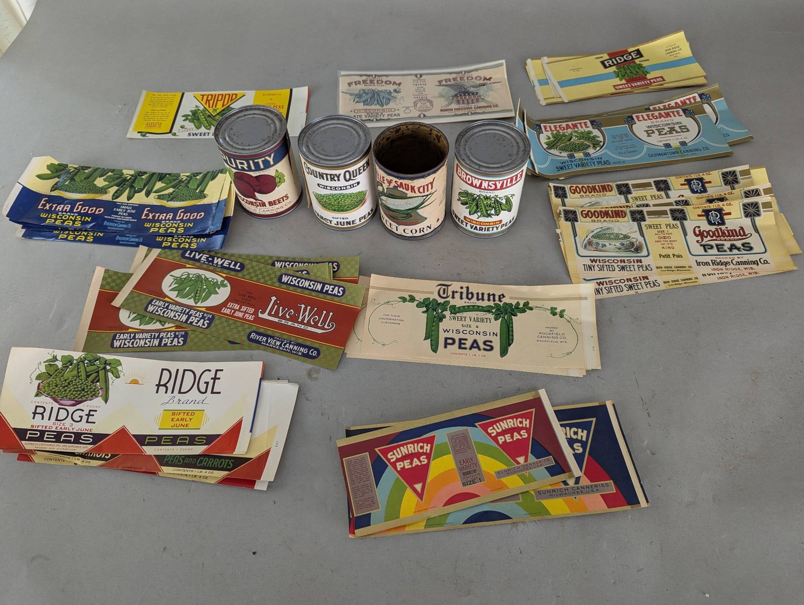 Large Lot NOS Food Can Labels with Four Vintage Cans: **Important** Please read below description on how to avoid high shipping costs. NOS (New Old Stock) vintage can labels featuring designs and brands including Purity, Ridge, Elegante, Country Queen,