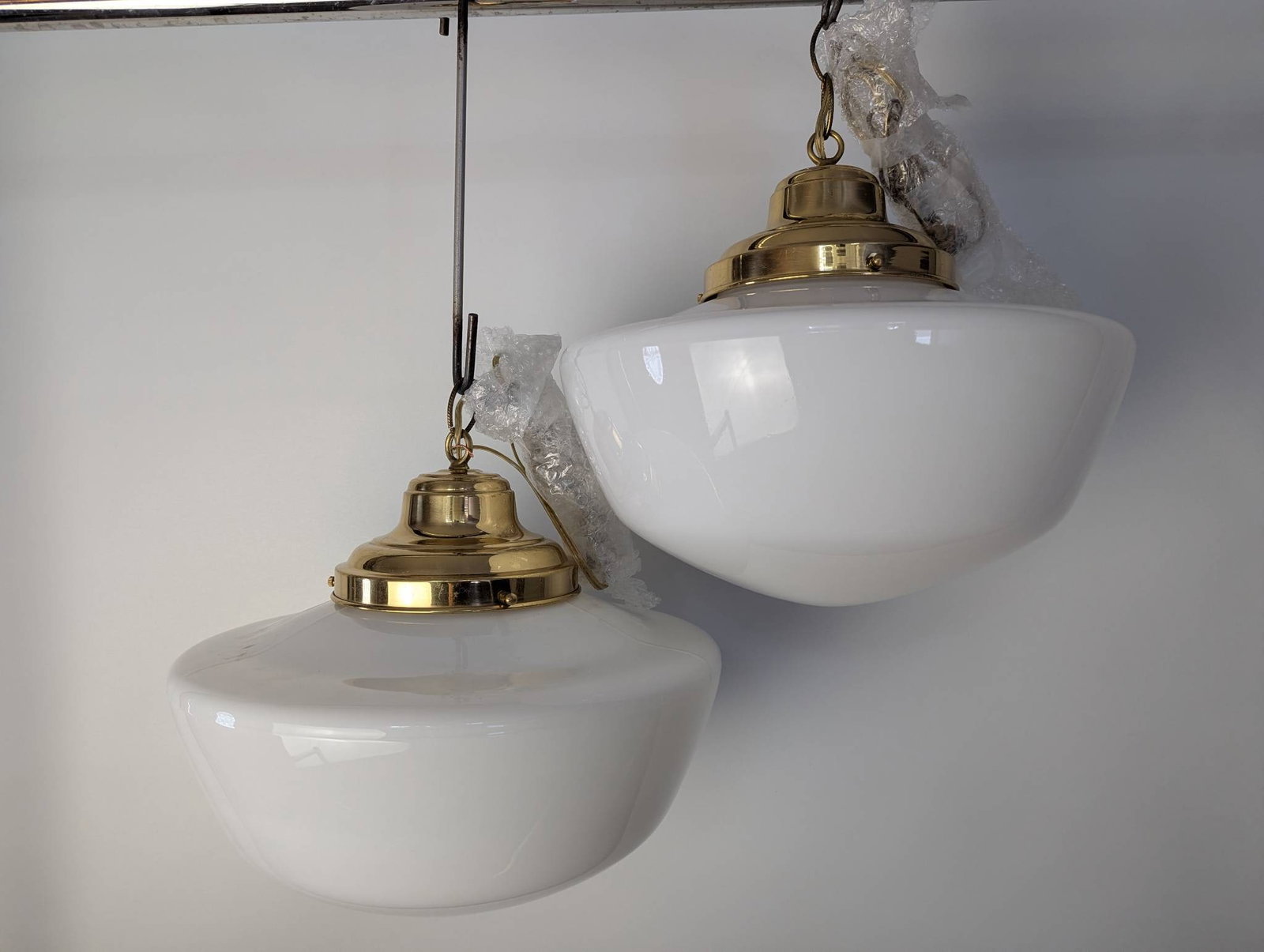 Pair Schoolhouse Pendant Lights with Brass and Opal Glass Shades: **Important** Please read below description on how to avoid high shipping costs. Rewired schoolhouse pendant lights featuring polished brass fittings and white opal glass shades. Ready to hang, each