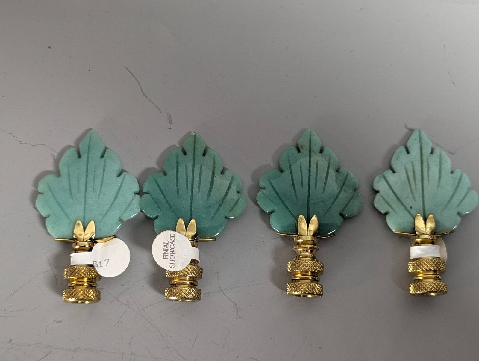 4 Polished Brass Leaf Lamp Finials with Green Jade Stone: **Important** Please read below description on how to avoid high shipping costs. Four Royal Designs leaf lamp finials crafted in a polished brass finish with a protective lacquer coating to resist