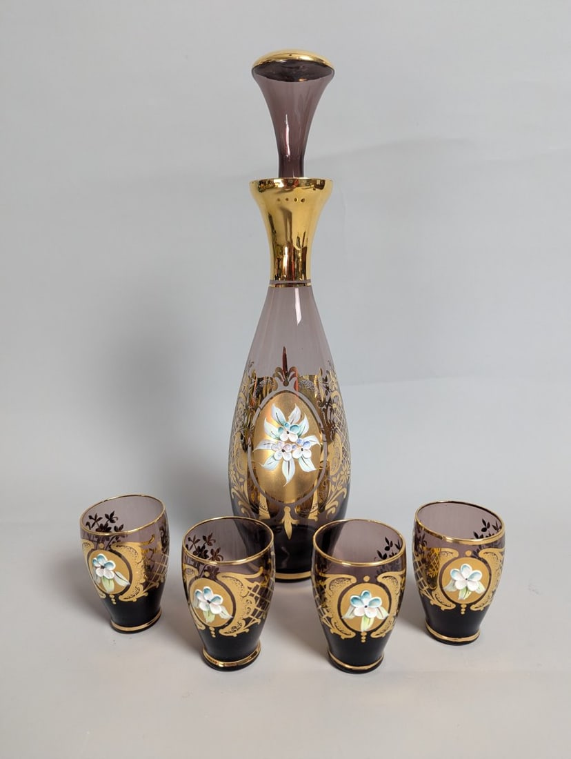 Italian Venetian-Style Amethyst Glass Liqueur Set with Gold Gilt and Enamel Flowers: **Important** Please read below description on how to avoid high shipping costs. This exquisite 5-piece cordial set features a stunning liqueur decanter standing 12 inches high with a diameter of 3.5