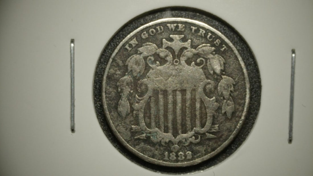 1882 Shield Nickel Five Cent Piece - Repunched Date Graded Fine by Longacre: **Important** Please read below description on how to avoid high shipping costs. This is an 1882 Shield Nickel Five Cent Piece, graded Fine (F). A sought-after Repunched Date variety, this coin exhibi
