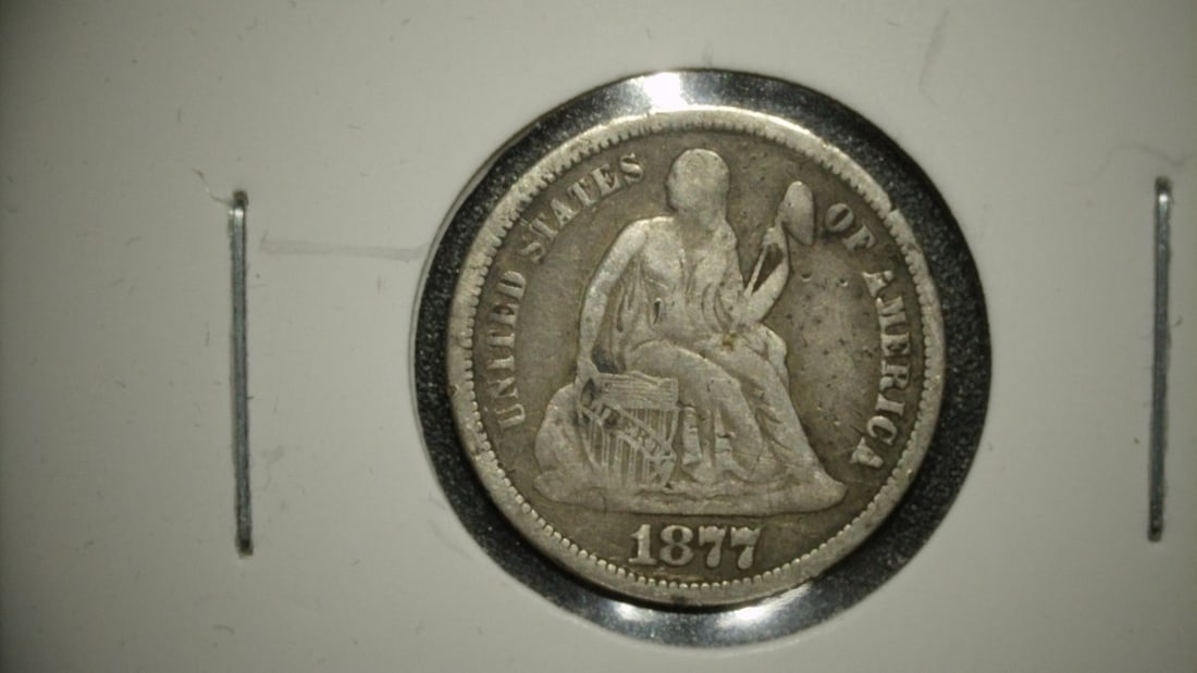 1877 Seated Liberty Dime V.G. by Christian Gobrecht, 90% Silver Coin: **Important** Please read below description on how to avoid high shipping costs. Presenting a stunning 1877 Seated Liberty Dime, graded 'Very Good' (V.G.), designed by Christian Gobrecht. This coin sh