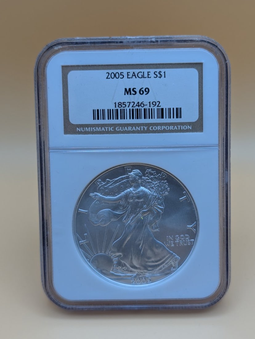 2005 American Silver Eagle $1 Coin NGC MS 69 - Adolph A. Weinman Walking Liberty Design: **Important** Please read below description on how to avoid high shipping costs. Up for auction is a stunning 2005 American Silver Eagle $1 Coin, graded NGC MS 69, indicating a near-perfect